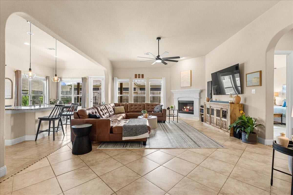 1413 Coffee Mill Court, League City, TX 77573 The open-concept living area features a cozy fireplace and flows seamlessly into the chef-inspired kitchen