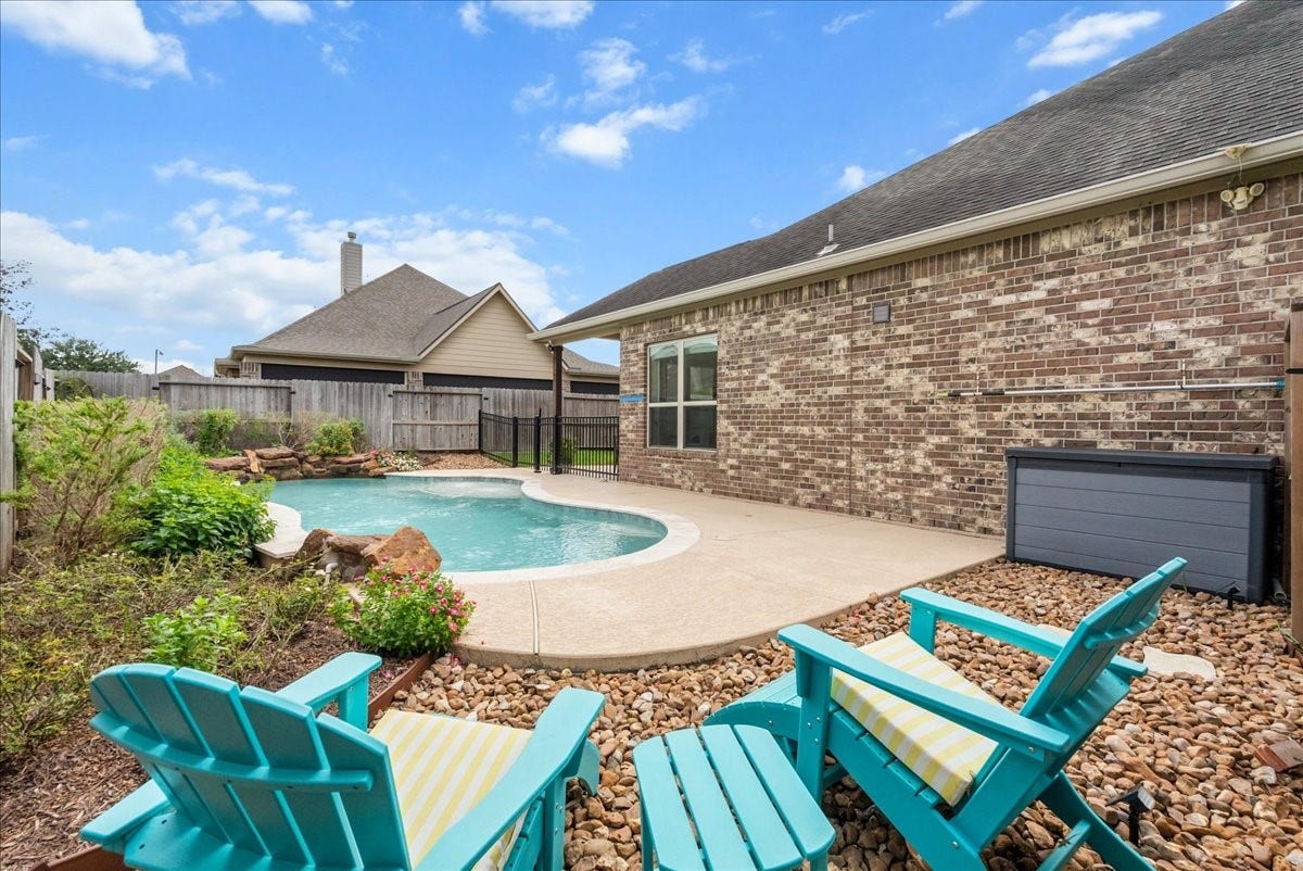 1413 Coffee Mill Court, League City, TX 77573 Step outside to your private backyard oasis featuring a sparkling pool, extended patio perfect for entertaining, and plenty of additional yard space for the kids to play.