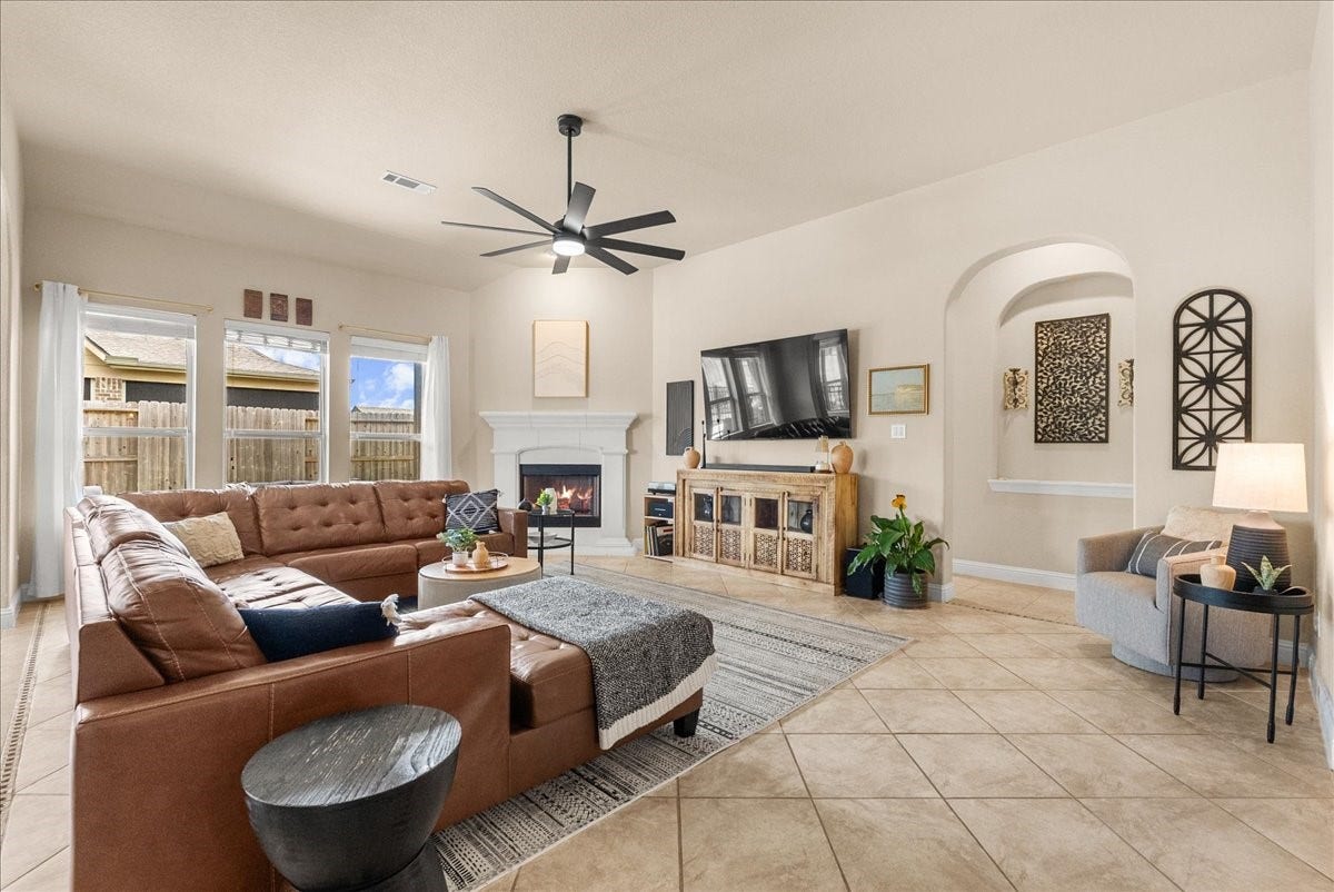 1413 Coffee Mill Court, League City, TX 77573 The open-concept living area features a cozy fireplace and flows seamlessly into the chef-inspired kitchen