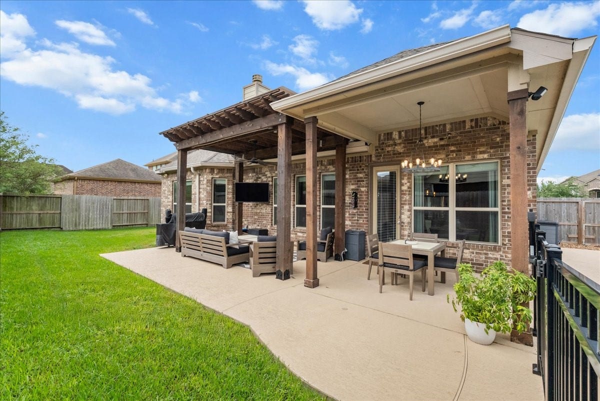 1413 Coffee Mill Court, League City, TX 77573 Step outside to your private backyard oasis featuring a sparkling pool, extended patio perfect for entertaining, and plenty of additional yard space for the kids to play.