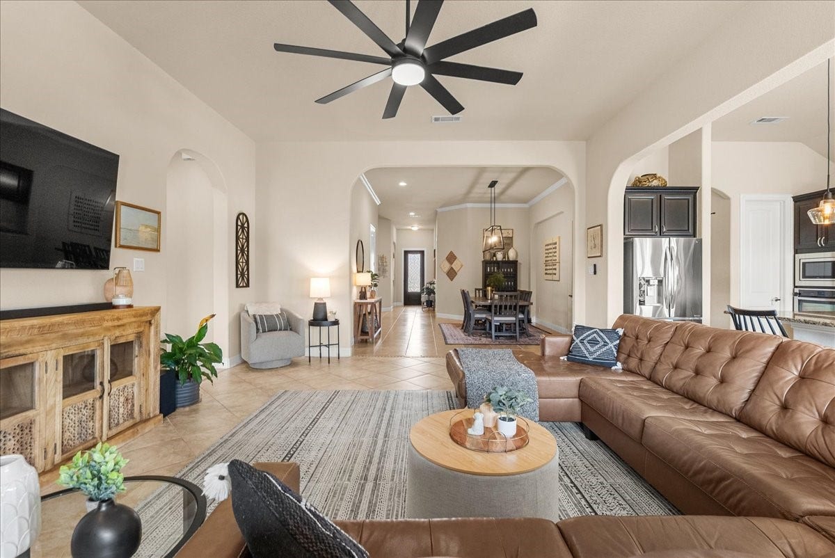 1413 Coffee Mill Court, League City, TX 77573 The open-concept living area features a cozy fireplace and flows seamlessly into the chef-inspired kitchen