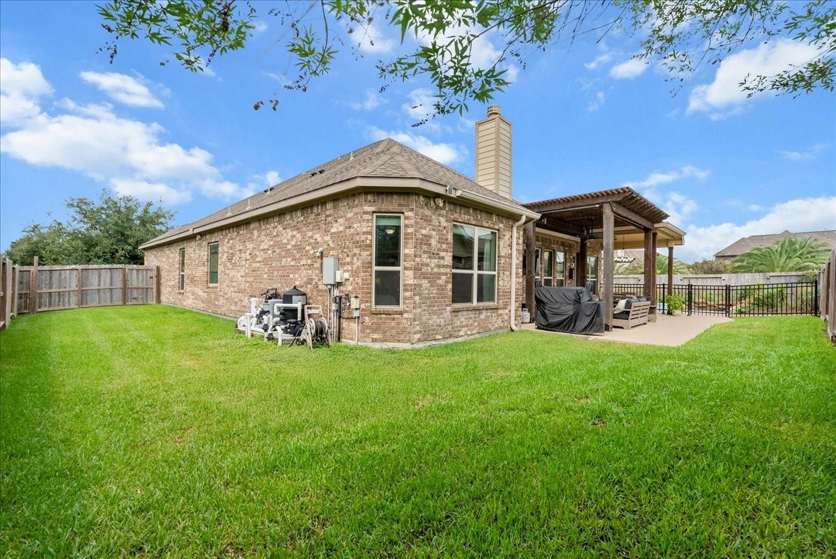 1413 Coffee Mill Court, League City, TX 77573 Step outside to your private backyard oasis featuring a sparkling pool, extended patio perfect for entertaining, and plenty of additional yard space for the kids to play.