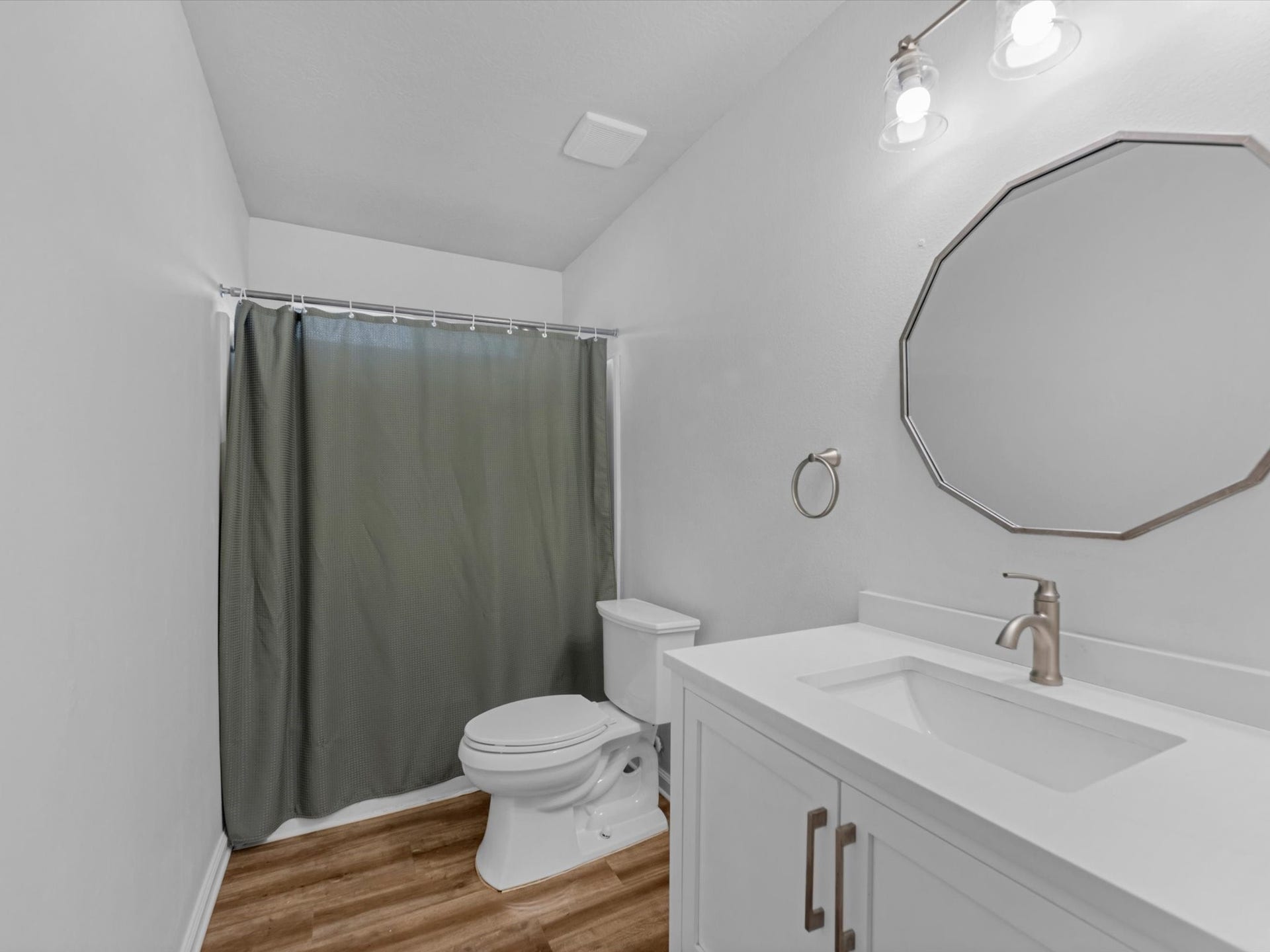 Guest Bathroom features updated vanity and light fixtures