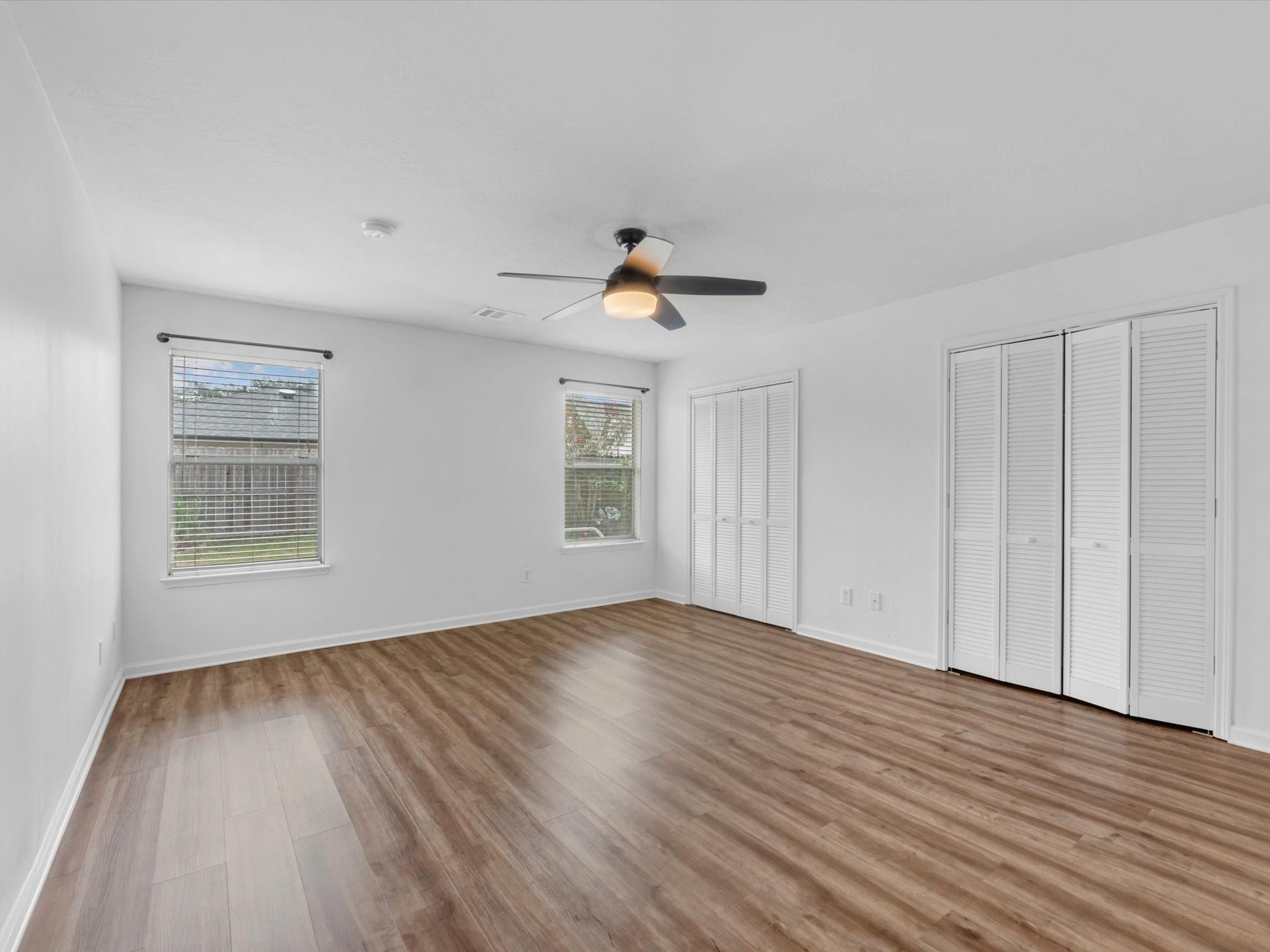 Primary bedroom features fresh paint, new light fixtures and 2 closets!