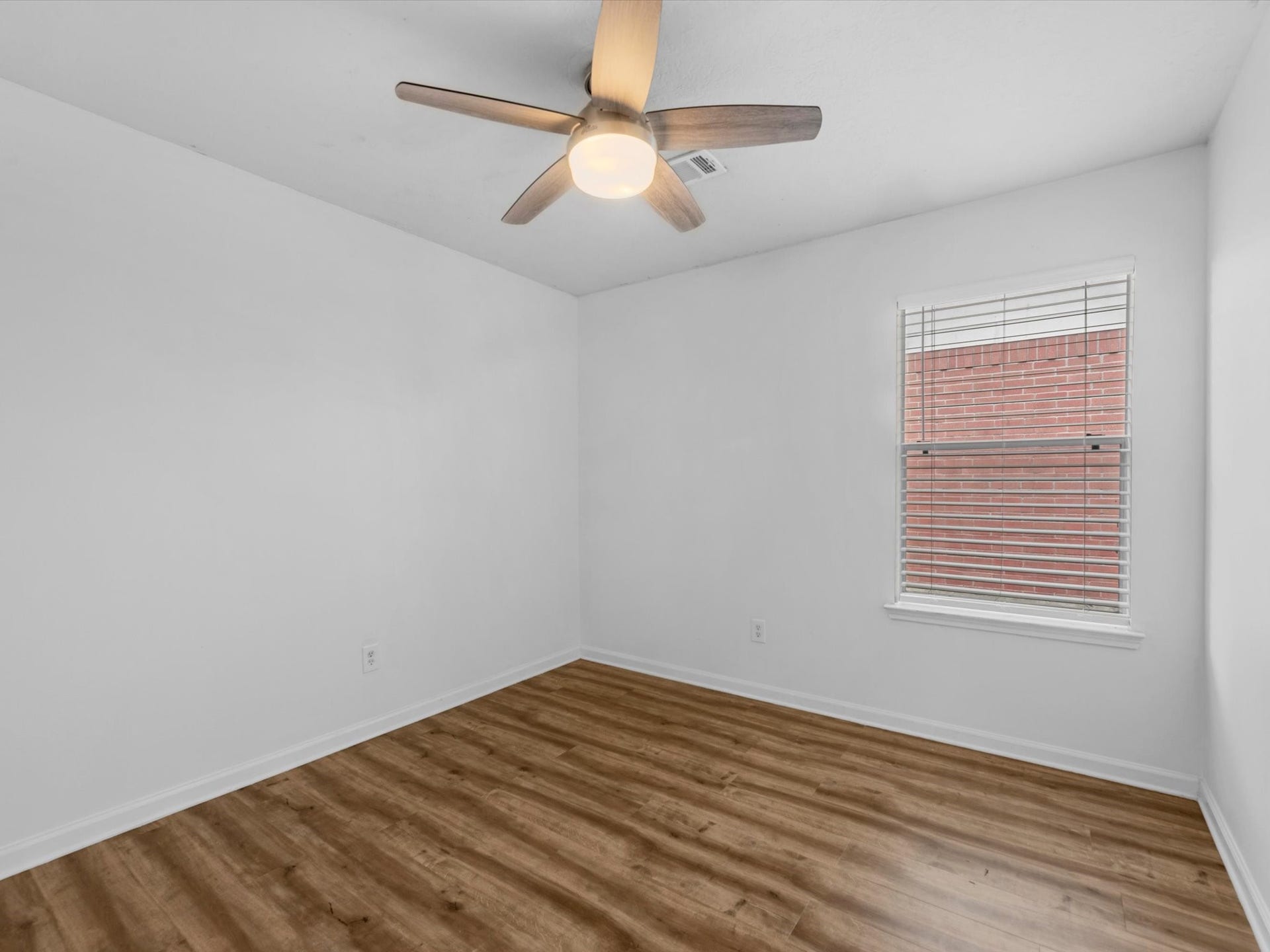 one of the secondary bedrooms with a ceiling fan for added comfort
