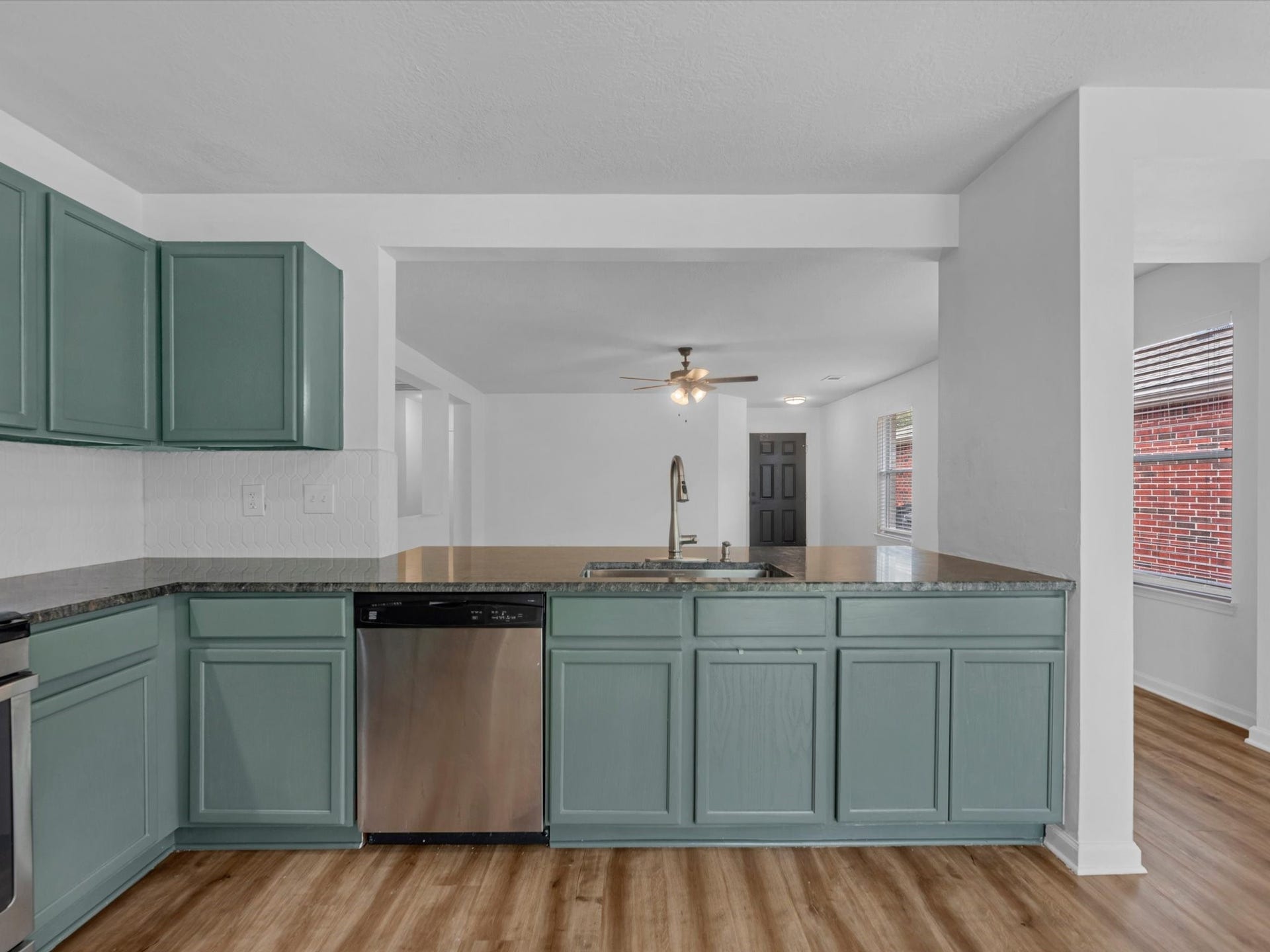 Perfect view of what hosting can look like in your new home! Enjoy cooking in the kitchen with easy access to chat with friends and family.