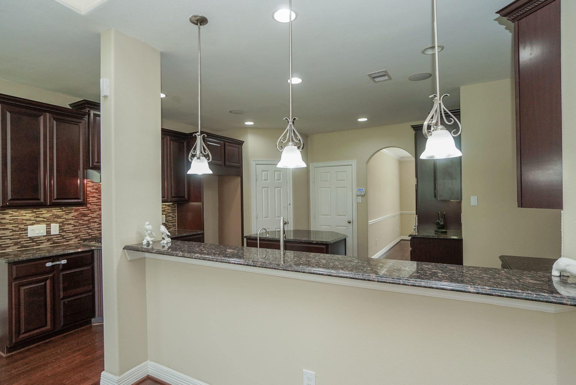 3434 Norwich Gardens Lane, Fulshear, TX 77441 The kitchen is the heart of the home: complete with upgraded lighting and granite countertops.