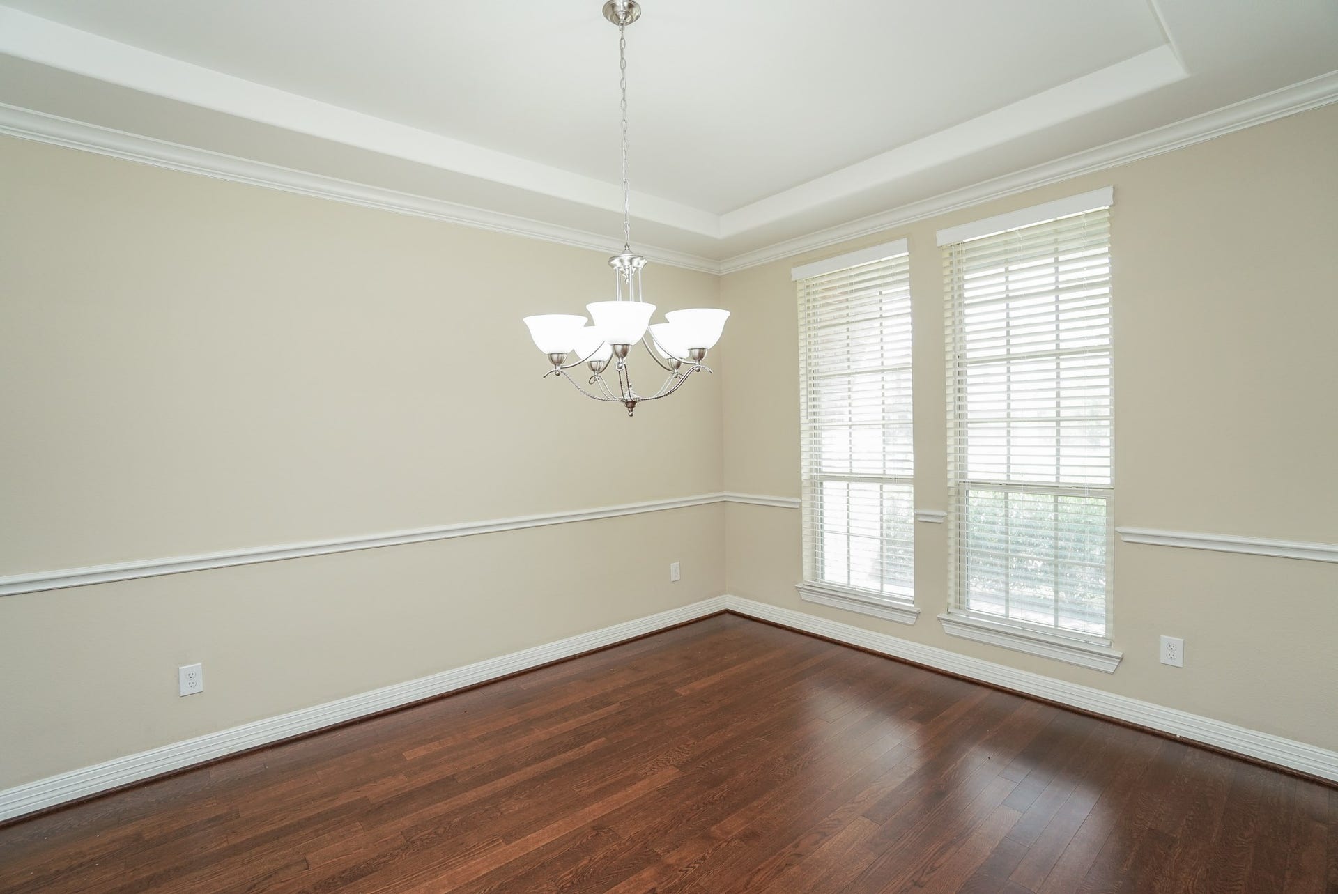 3434 Norwich Gardens Lane, Fulshear, TX 77441 The formal dining room is on the right side of the front door. Neutral paint, extensive crown molding and rich hardwood flooring add to the elegance of this space.