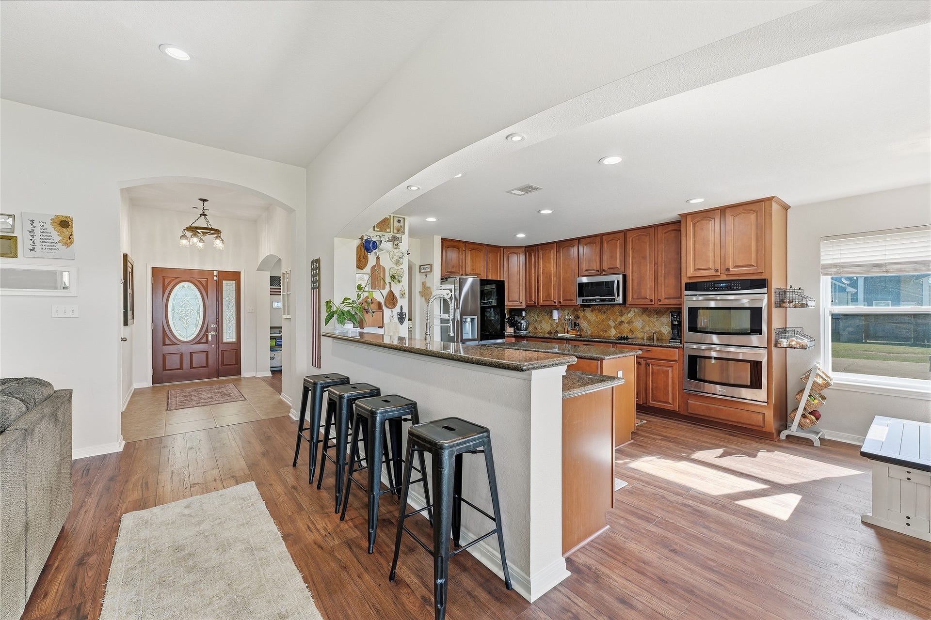10711 Indian Trails Drive, Tomball, TX 77375 Spacious kitchen with bar seating, new LVP flooring, a 2026 LG refrigerator and a 2025 GE dishwasher.