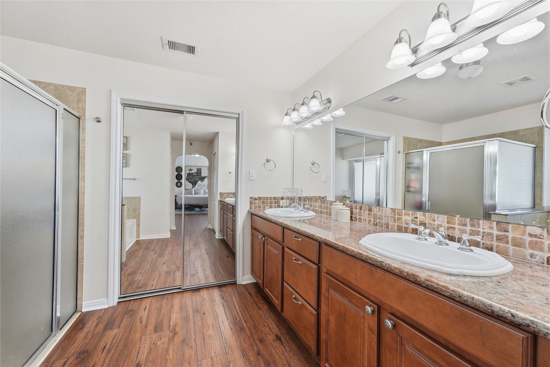 10711 Indian Trails Drive, Tomball, TX 77375 The primary bathroom offers dual vanities, granite countertops, generous storage and a large walk-in closet to keep everything organized.
