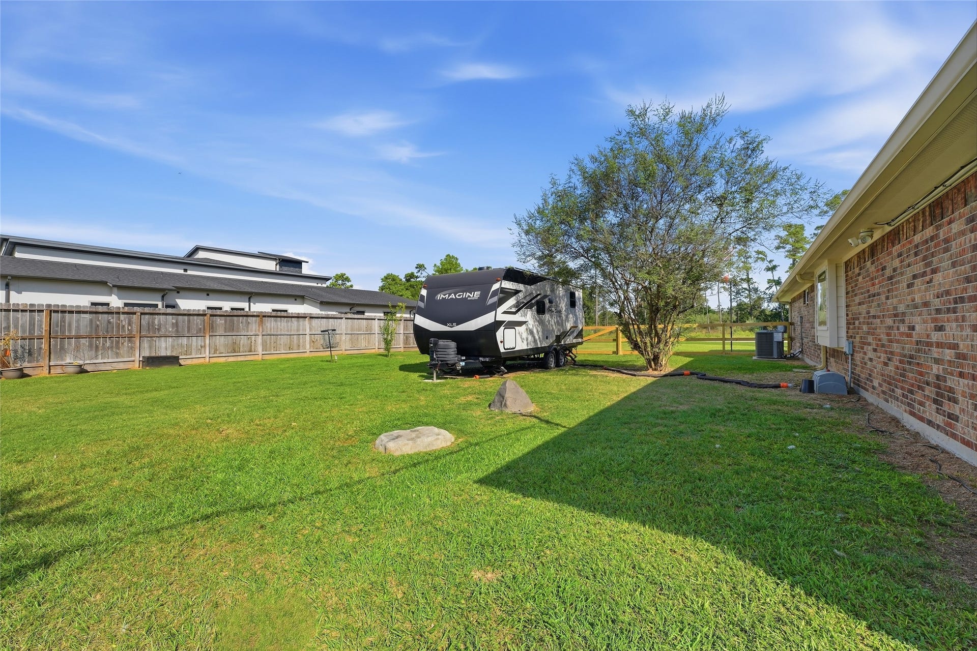 10711 Indian Trails Drive, Tomball, TX 77375 Keep your RV at home with extra parking space, two RV hookups and a generator hookup.
