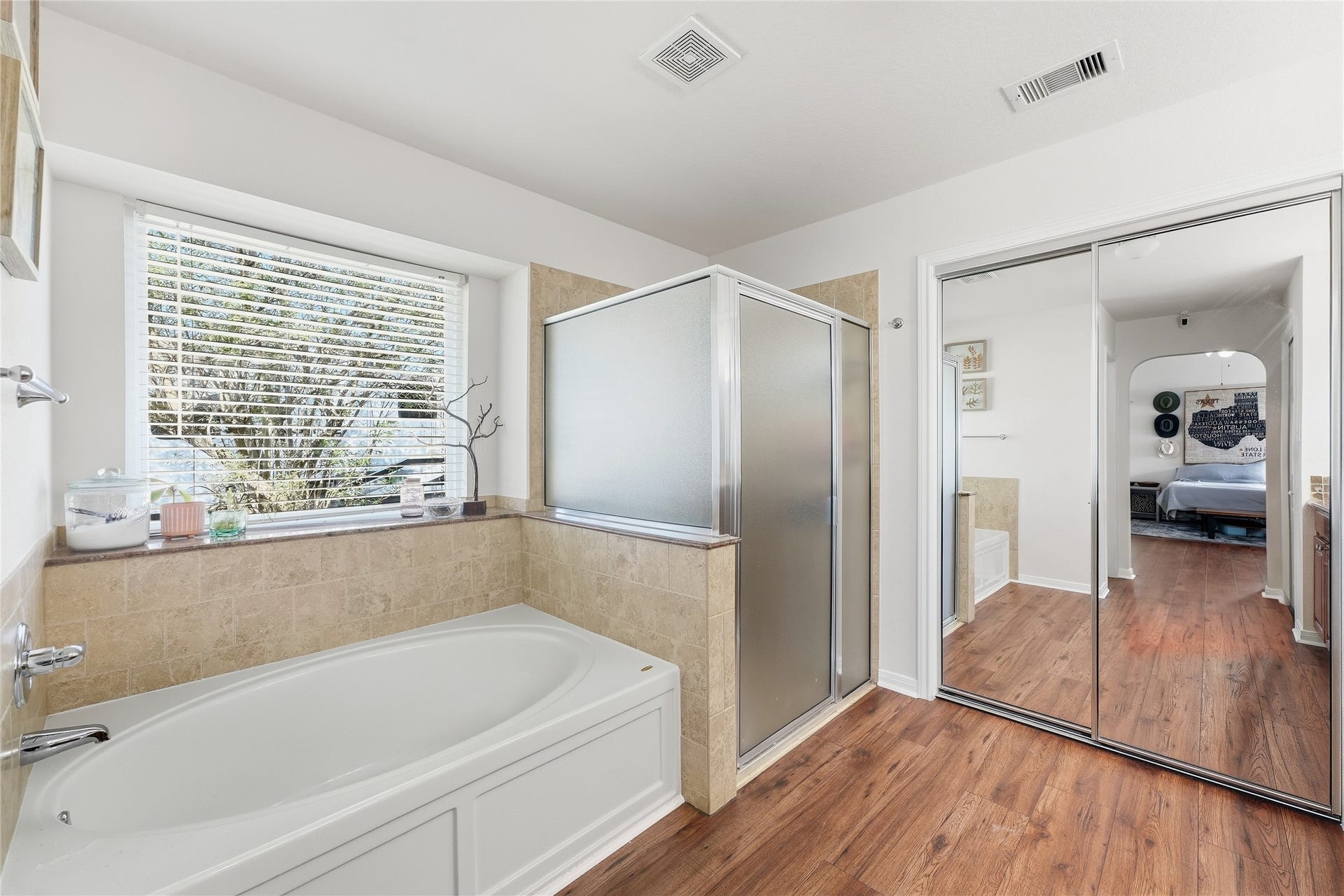 10711 Indian Trails Drive, Tomball, TX 77375 The primary bath features a separate shower and soaking tub, abundant natural light.
