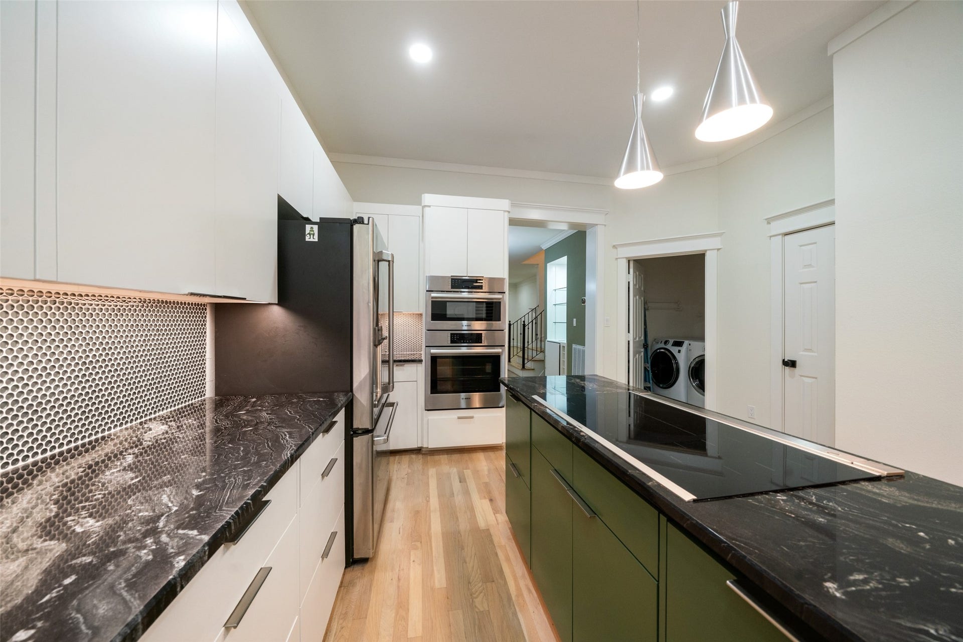 455 W 18th Street, Houston, TX 77008 Elegant countertops and green glass tile backsplash bring subtle color and contemporary sophistication.