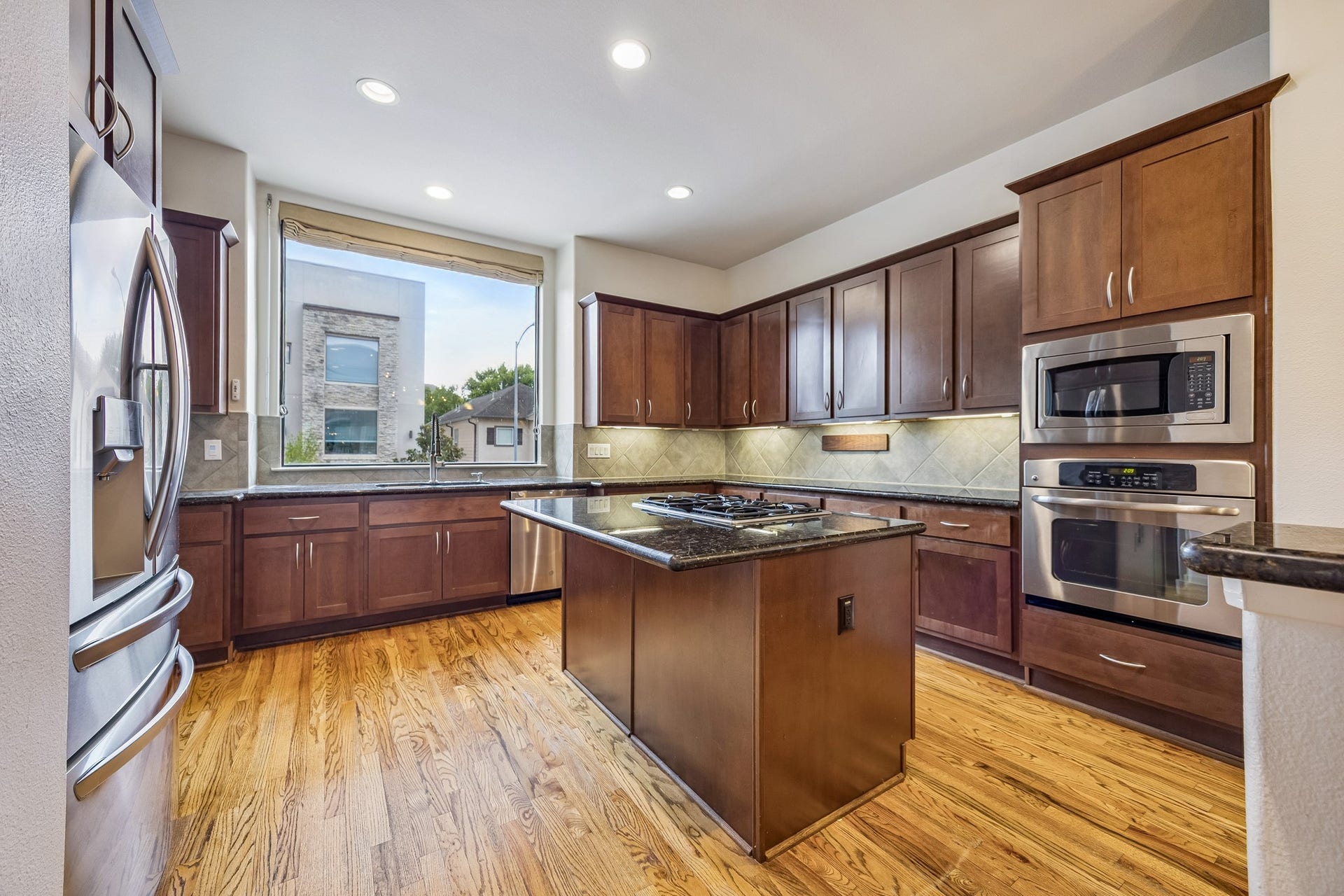 4414 Floyd Street, Houston, TX 77007 Spacious kitchen with warm cabinetry and stainless appliances