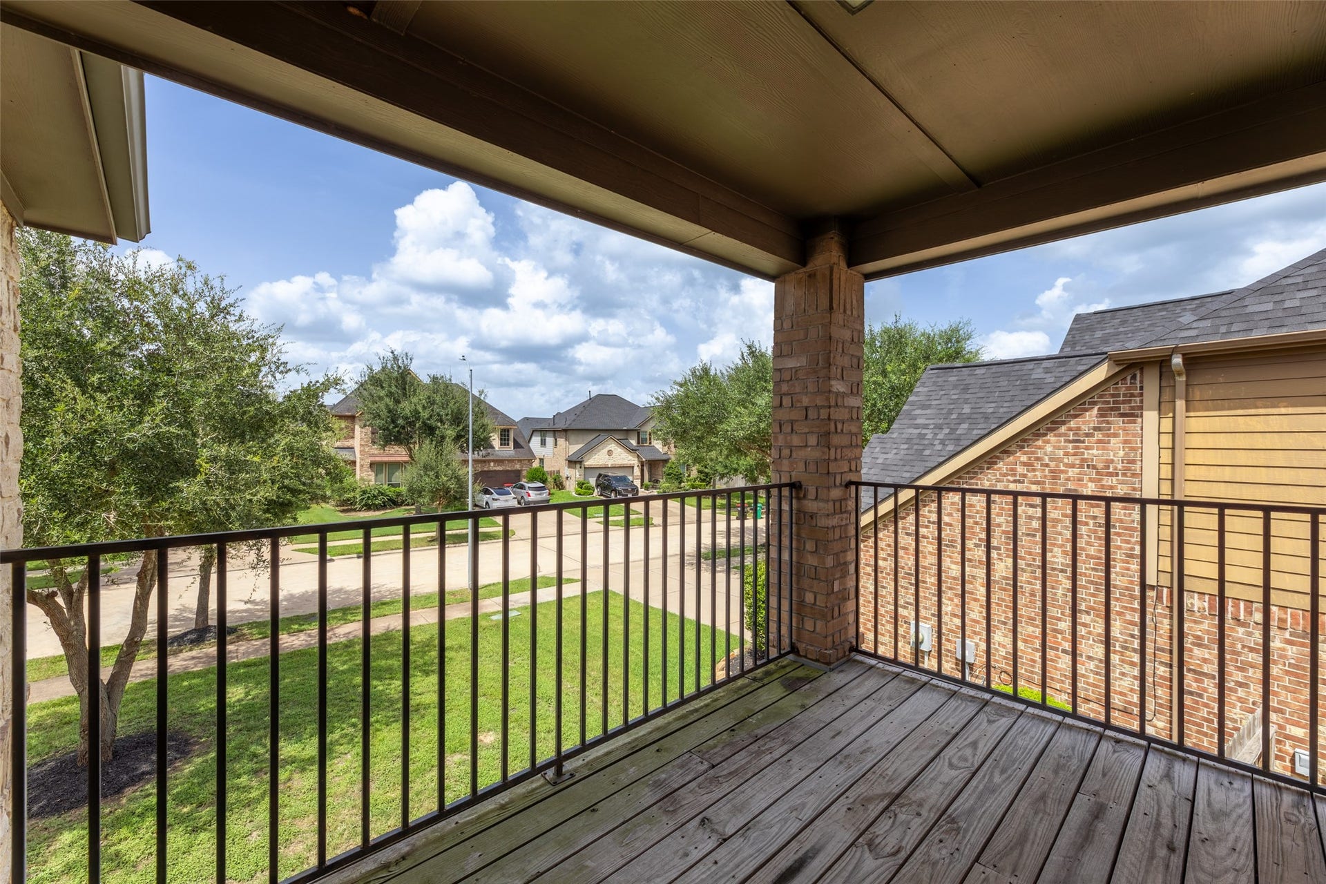 Serene neighborhood views from this charming covered balcony, perfect for relaxing outdoors.