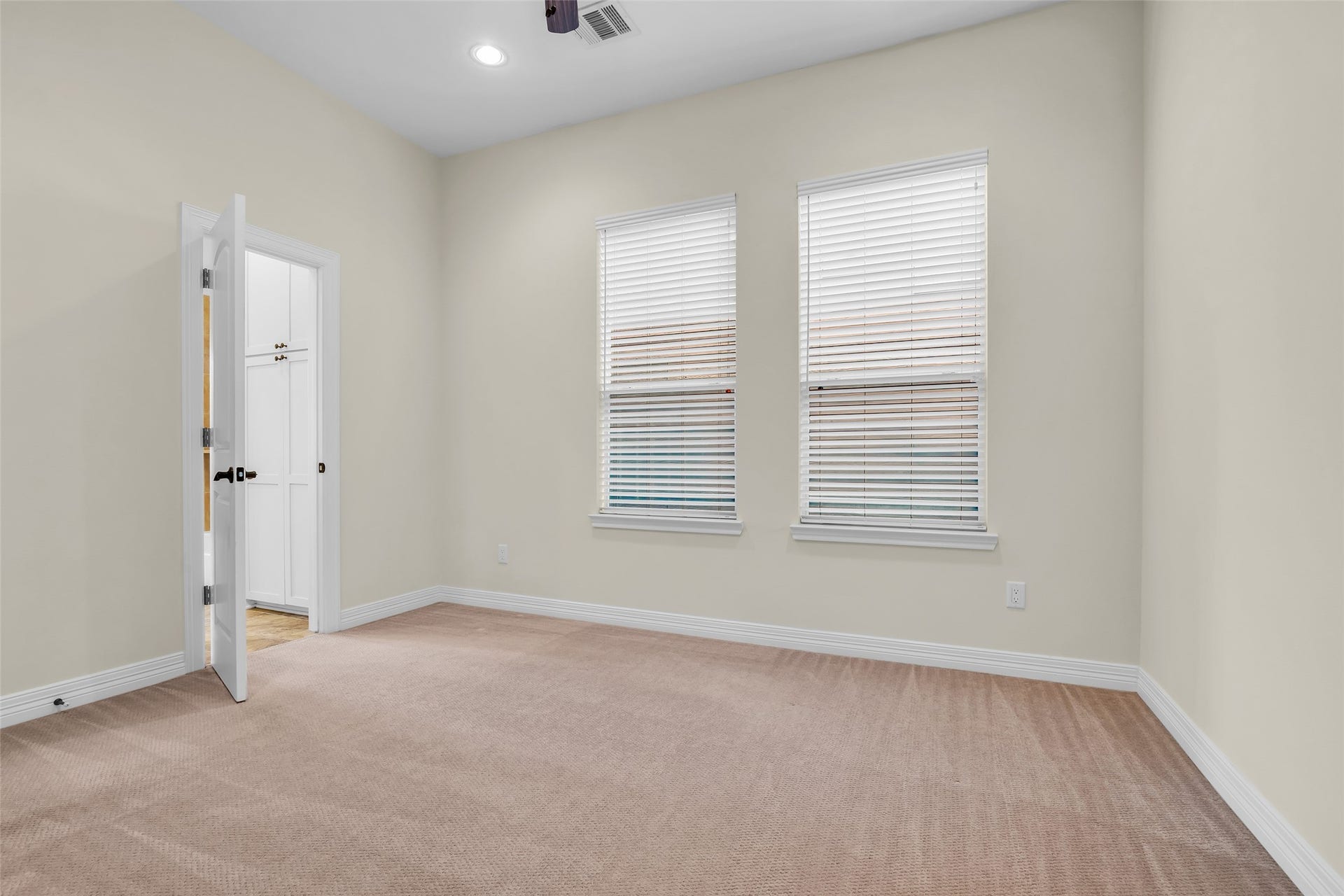 1423 Colorado Street, Houston, TX 77007 Another secondary bedroom on the second floor features carpeted flooring and windows overlooking the side of the home, providing natural light and a comfortable living space.