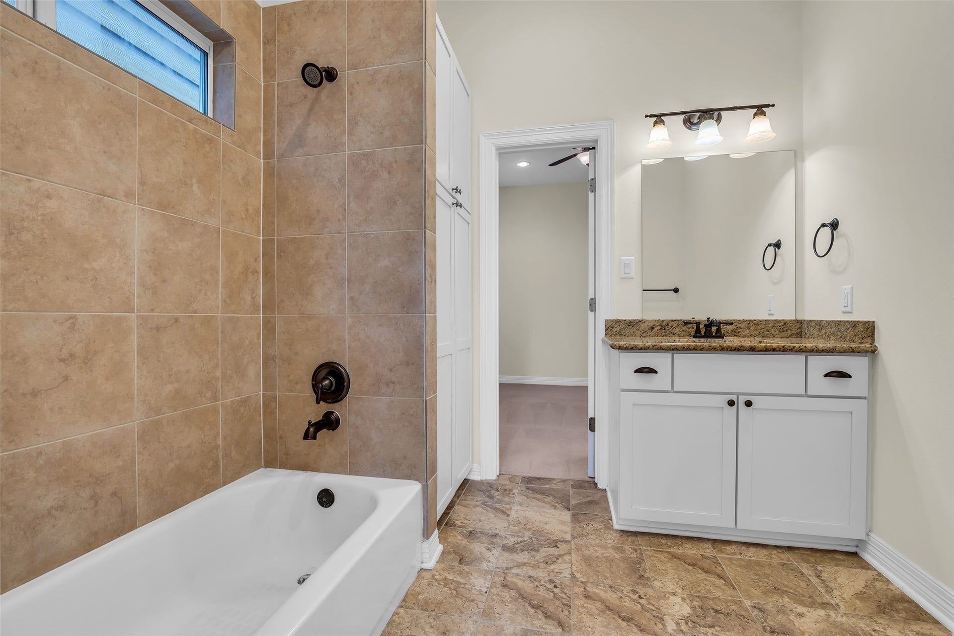 1423 Colorado Street, Houston, TX 77007 Shared bathroom between the two secondary bedrooms features a tub and shower combination, along with a single sink and practical finishes for everyday use.