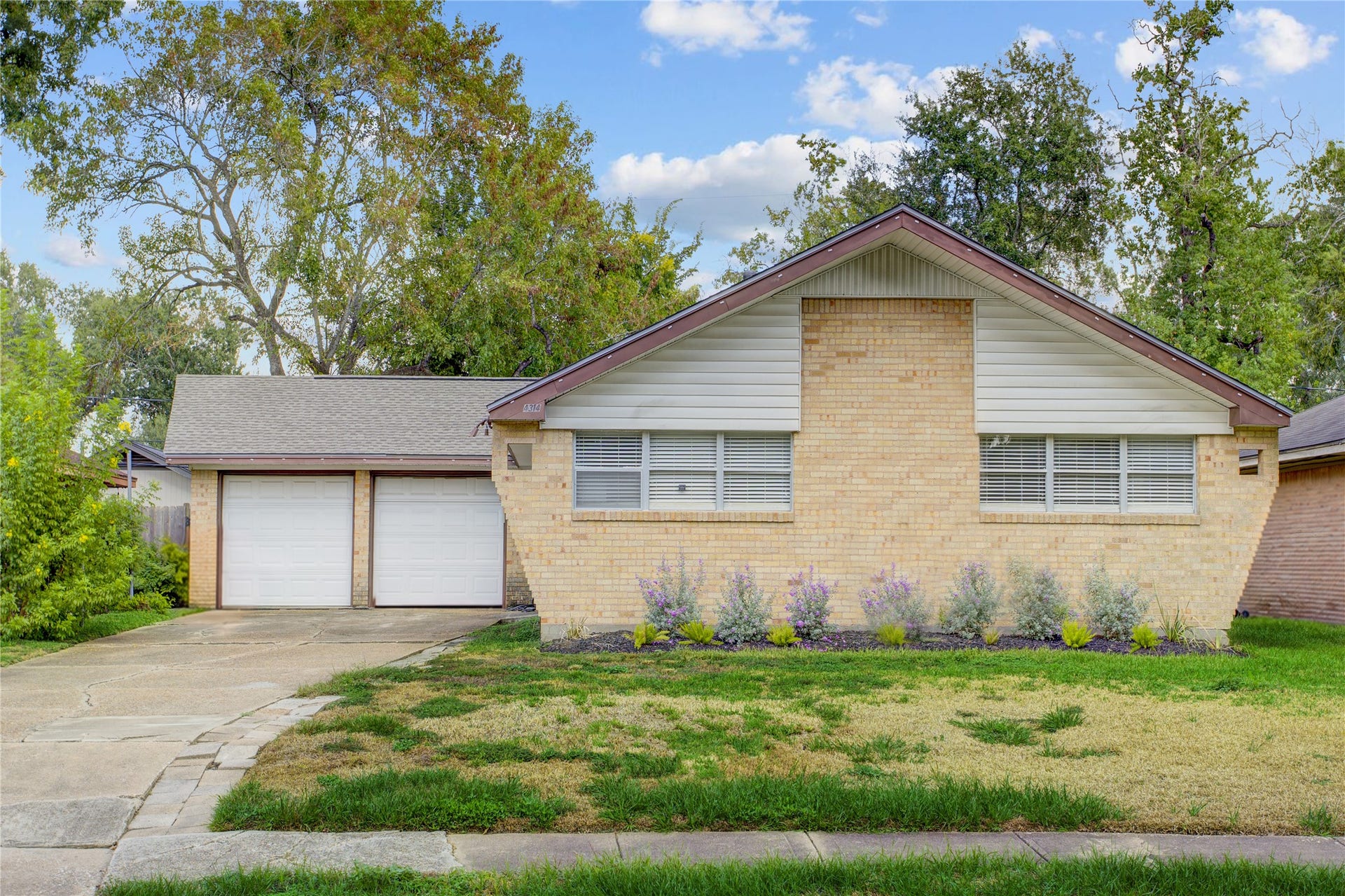 4314 Benning Drive, Houston, TX 77035 Mid-century cues on front elevation long driveway for great offstreet parking and two car garage attached. Note the tidy Landscaping and low maintenance yard.