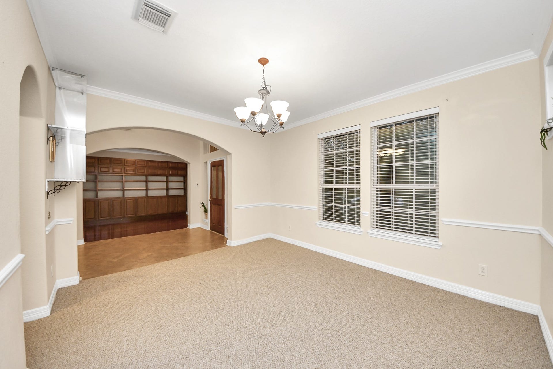 3003 Birch Landing Court, Pearland, TX 77584 A formal dining area through a wide archway shows off crown molding and sizeable windowsperfect for memorable gatherings.