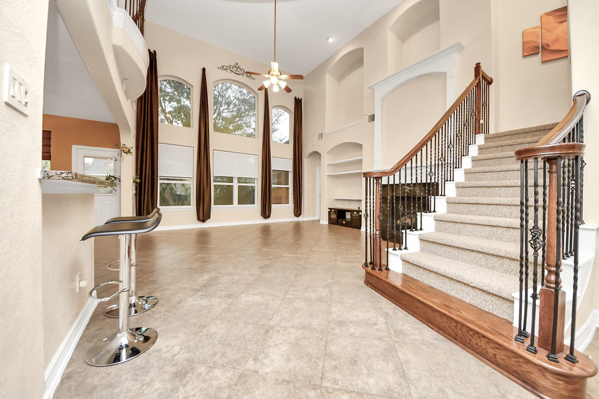 3003 Birch Landing Court, Pearland, TX 77584 Carpeted stairs ascend gracefully beside the living area, adding a soft visual rhythm to the open design.