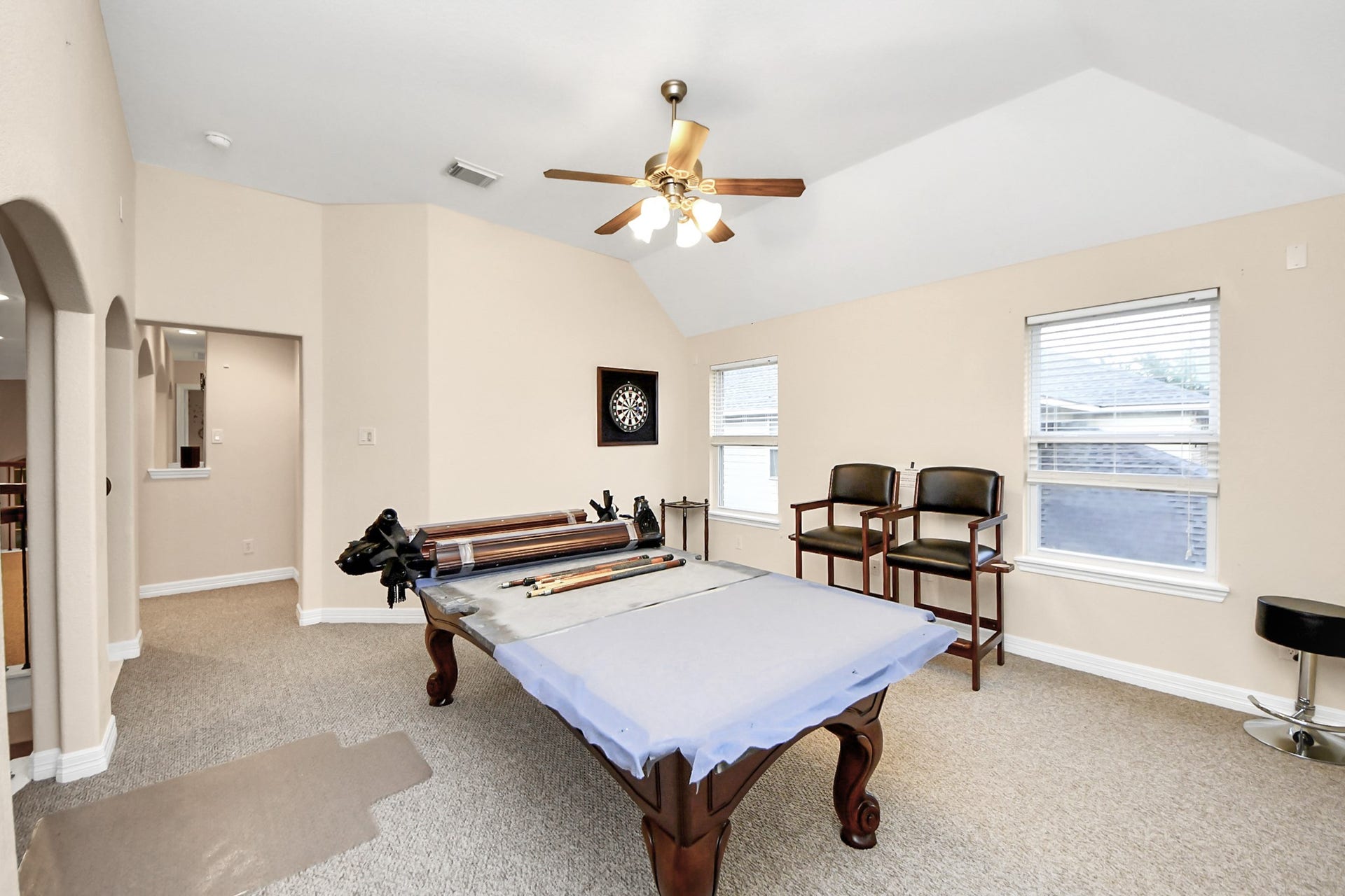 3003 Birch Landing Court, Pearland, TX 77584 The game room loft delivers openness and versatility, enhanced by numerous windows, a ceiling fan, and views over the main living space.