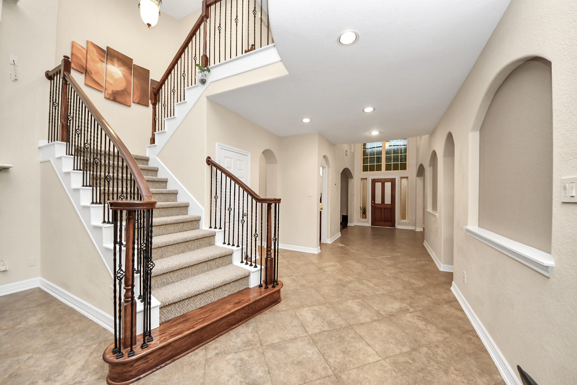 3003 Birch Landing Court, Pearland, TX 77584 From the interior, the front entry is brightened by transom windows and sidelights, while the hallway lined with arches guides the eye inward.