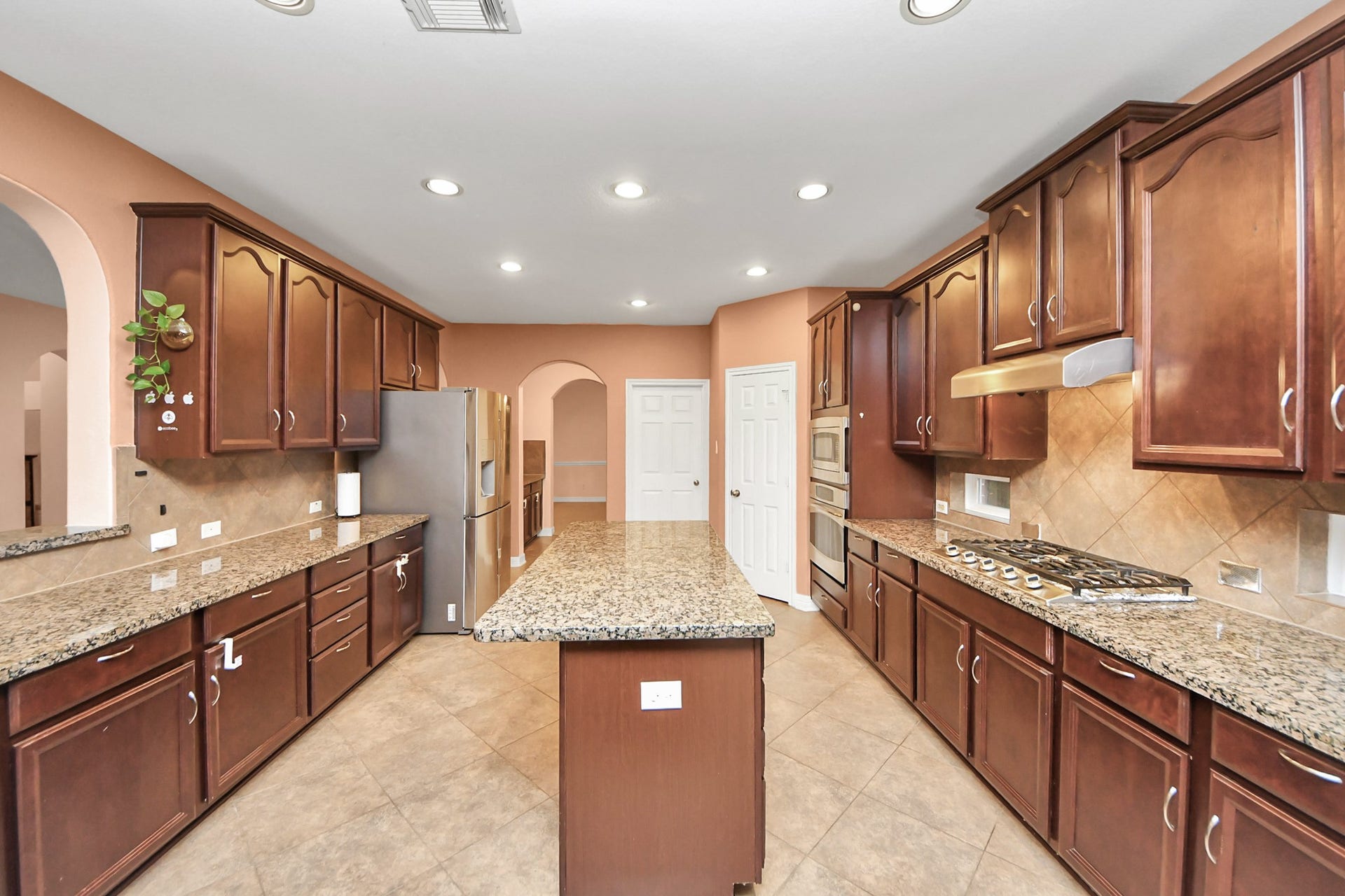 3003 Birch Landing Court, Pearland, TX 77584 Glossy countertops and abundant storage create a polished culinary environment with ample room for prep and organization.