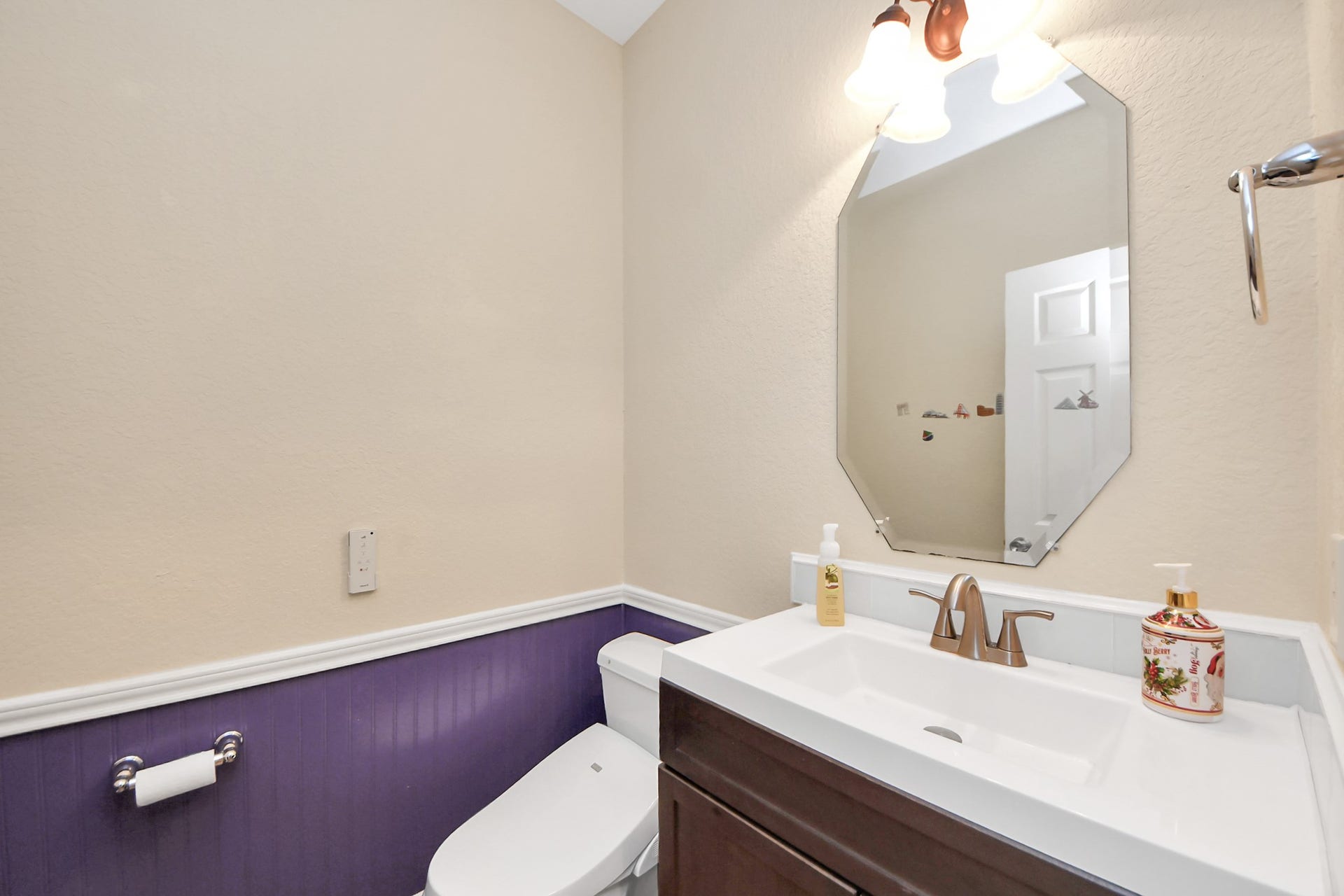 3003 Birch Landing Court, Pearland, TX 77584 The half bath features charming wainscoting and a tidy vanity, adding character and convenience.