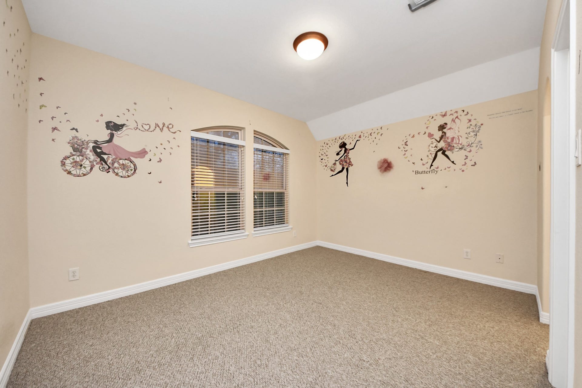3003 Birch Landing Court, Pearland, TX 77584 Another carpeted bedroom reveals soft tones, arched windows that complement the ceiling slope, and a personal vanity area.