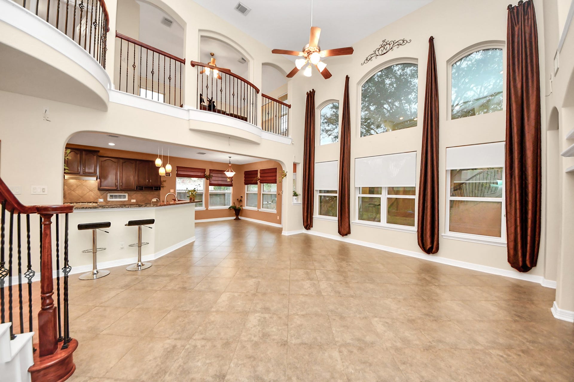 3003 Birch Landing Court, Pearland, TX 77584 Stacked windows pour in natural light into the living room, enhancing the sense of scale across the two-story height.
