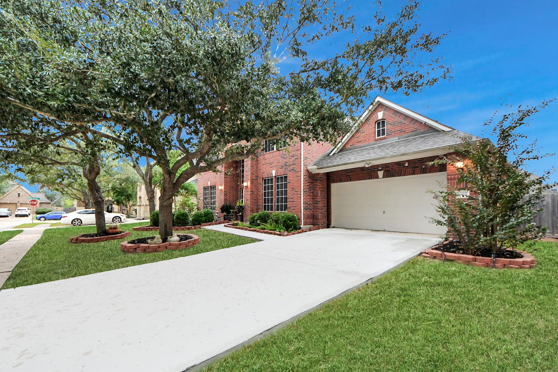 3003 Birch Landing Court, Pearland, TX 77584 An angled view spotlights the garage and refreshed driveway, lending a nice crisp contrast against the rich brick exterior.