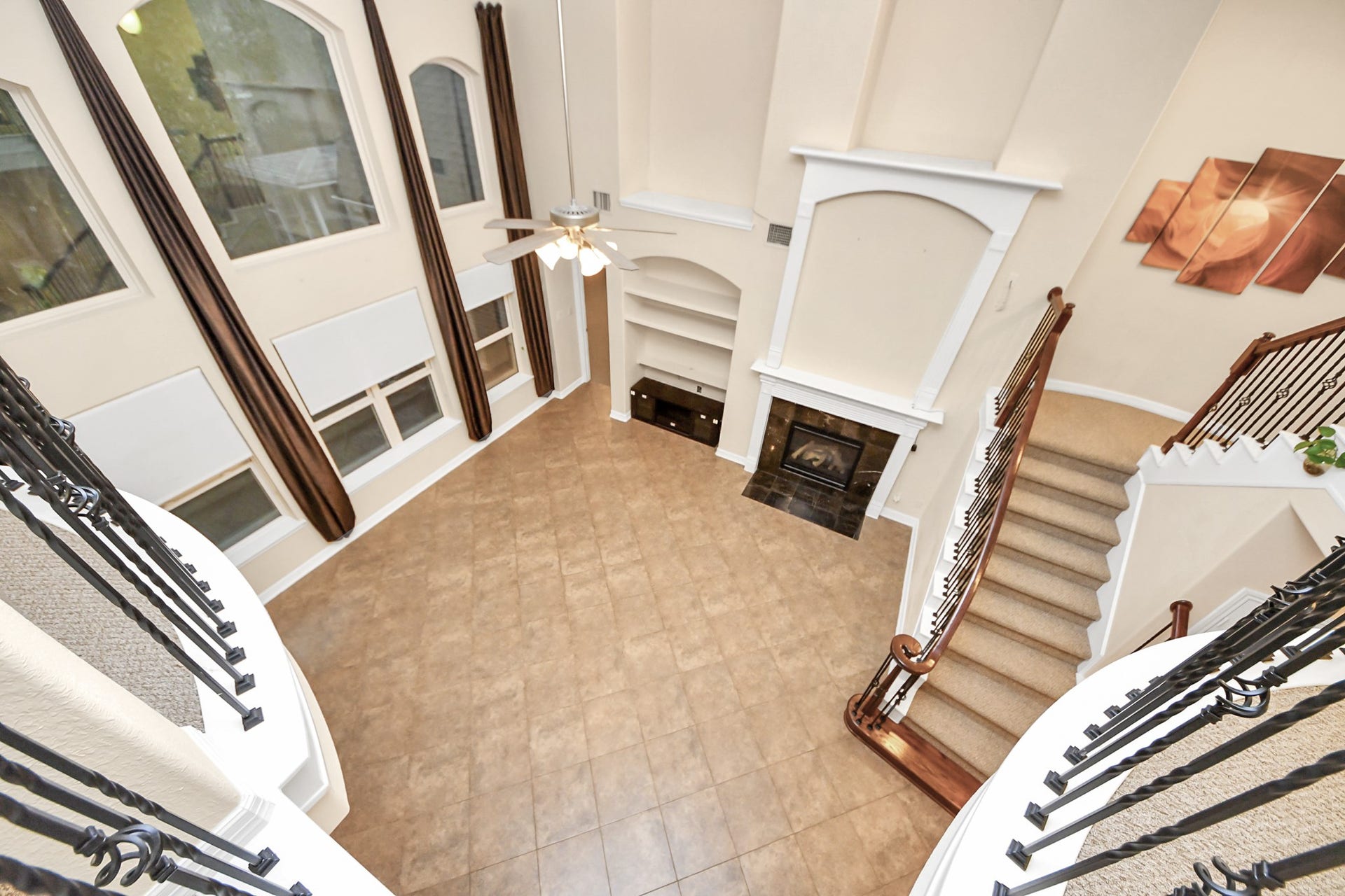 3003 Birch Landing Court, Pearland, TX 77584 A view from above highlights the living rooms vertical expanse, emphasizing its grand proportions.