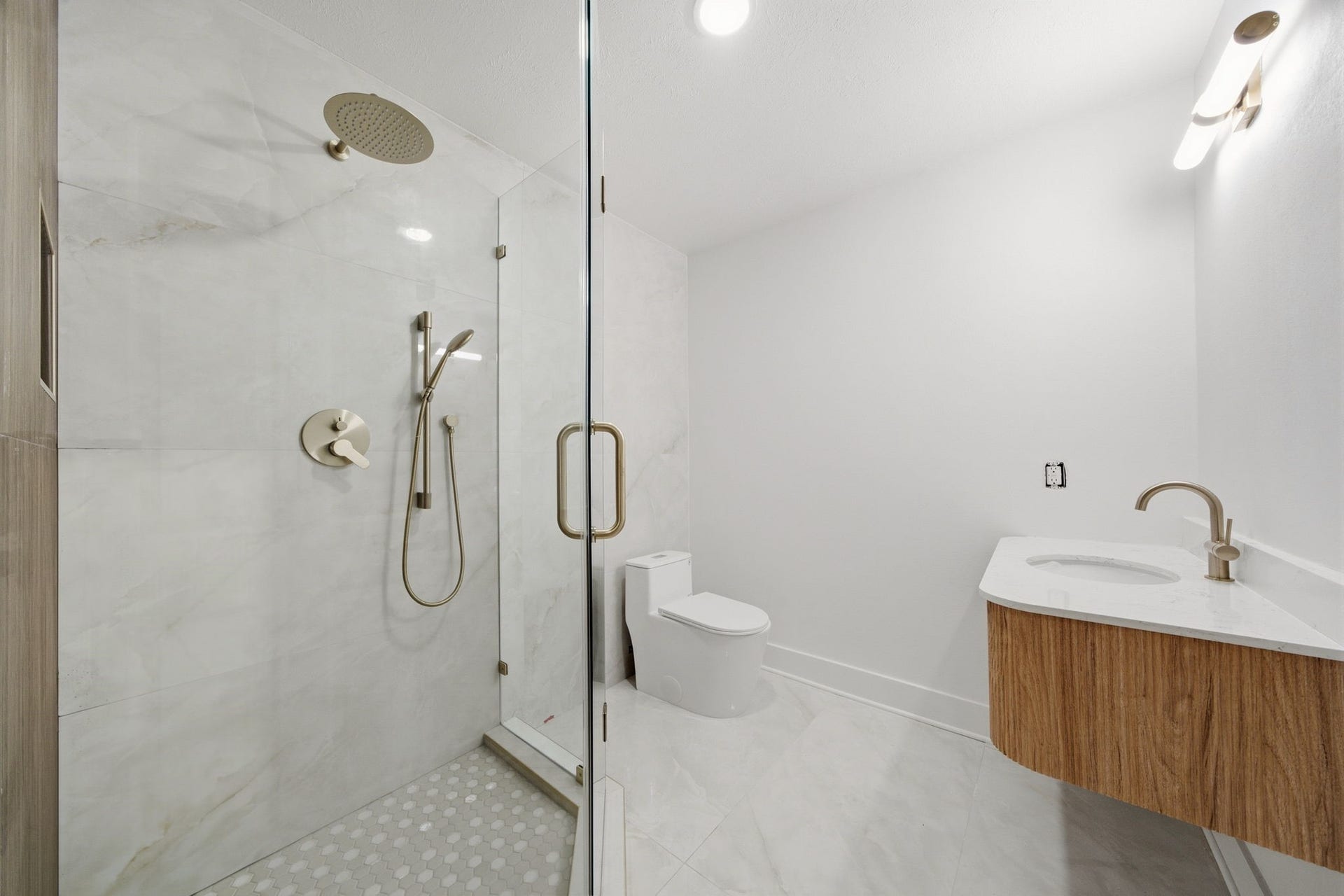 2304 Eagles Way, Pearland, TX 77581 Stylish full bathroom features a spacious glass enclosed shower with rainfall and hand held fixtures, paired with a modern floating vanity.