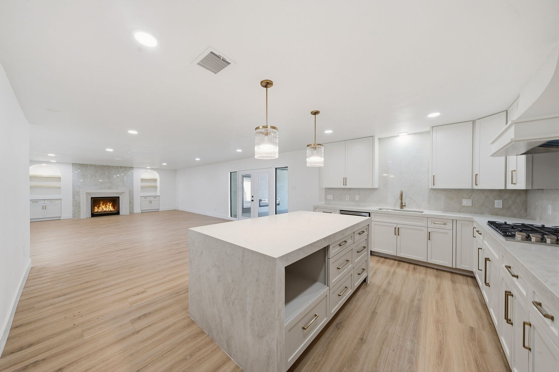 2304 Eagles Way, Pearland, TX 77581 Showpiece kitchen featuring Taj Mahal surfaces, designer lighting and a large central island.