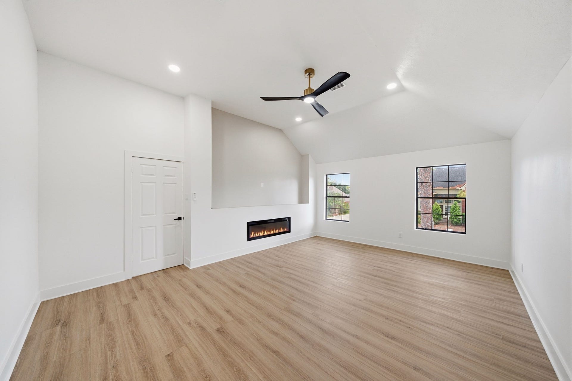 2304 Eagles Way, Pearland, TX 77581 Expensive primary bedroom with vaulted ceilings and cozy electric fireplace.