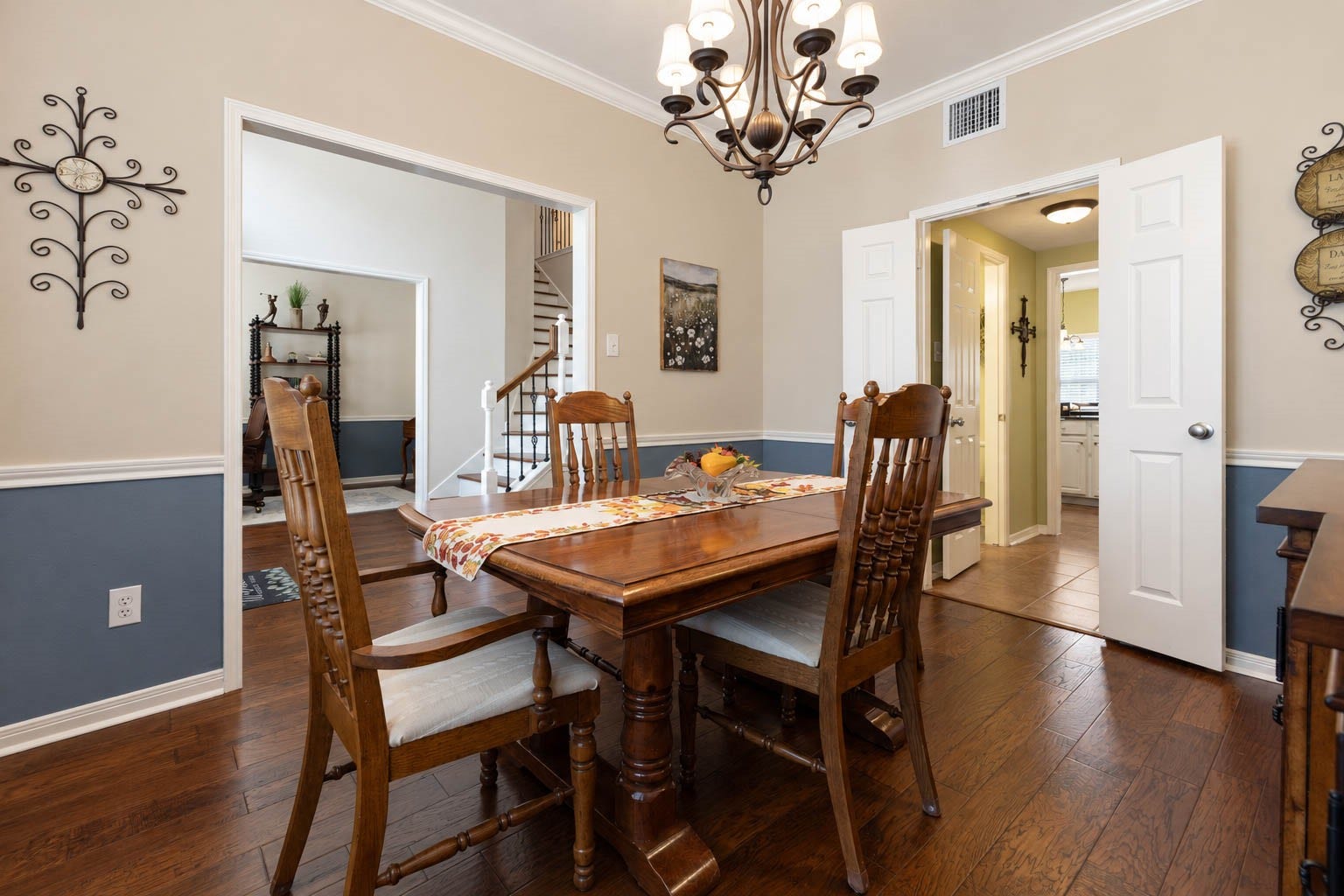 2532 Oak Dale Way, Seabrook, TX 77586 Just to the right of the foyer, the formal dining room carries the same tailored palette as the study, with two tone paint, a classic chair rail, and crown molding. A graceful chandelier hangs overhead, and double doors open toward the kitchen, making it easy to serve and host for gatherings large or small.
