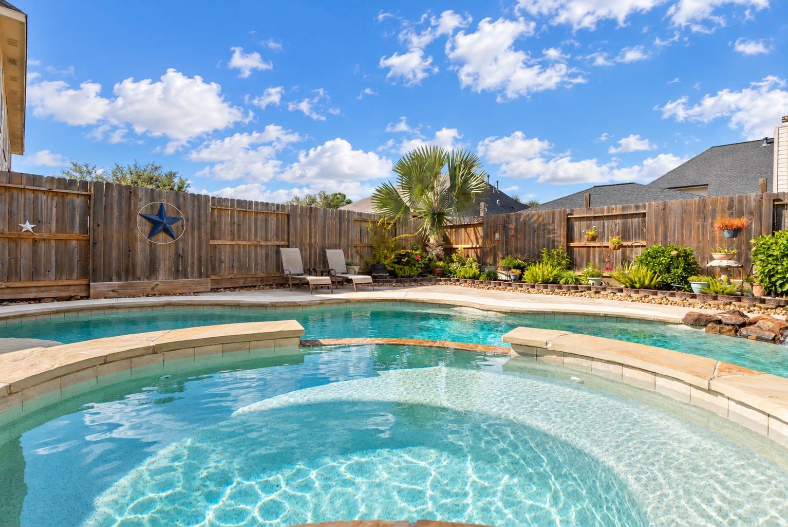 2532 Oak Dale Way, Seabrook, TX 77586 Crystal clear water fills this pool and spa, framed by natural stone coping and a small rock waterfall feature. Carefully tended landscaping lines the perimeter with tropical plants and colorful blooms.