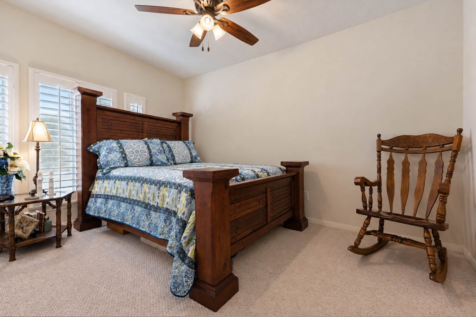 2532 Oak Dale Way, Seabrook, TX 77586 Guest bedroom number two is a comfortable space with designer carpet, a ceiling fan, and windows dressed in plantation shutters that add a refined touch.