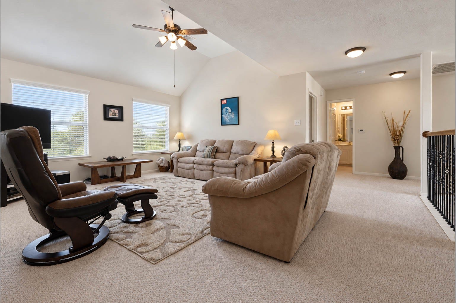 2532 Oak Dale Way, Seabrook, TX 77586 A pair of windows fills this game room with sunlight, highlighting the vaulted ceiling and soft carpet. The generous footprint makes it easy to arrange as a media room, play area, or home office.