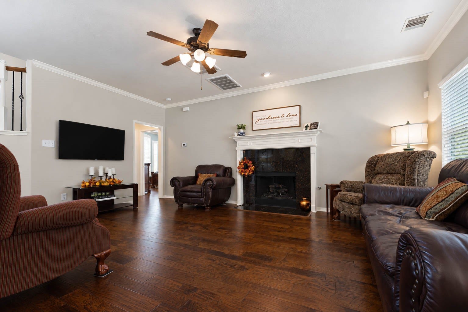 2532 Oak Dale Way, Seabrook, TX 77586 Unwind beside the fireplace, where a dark tile surround and crisp white mantel create a striking contrast. This roomy living area offers a flexible layout, with space for a sectional or a sofa and loveseat pairing, and a ceiling fan keeps the room comfortable year round.