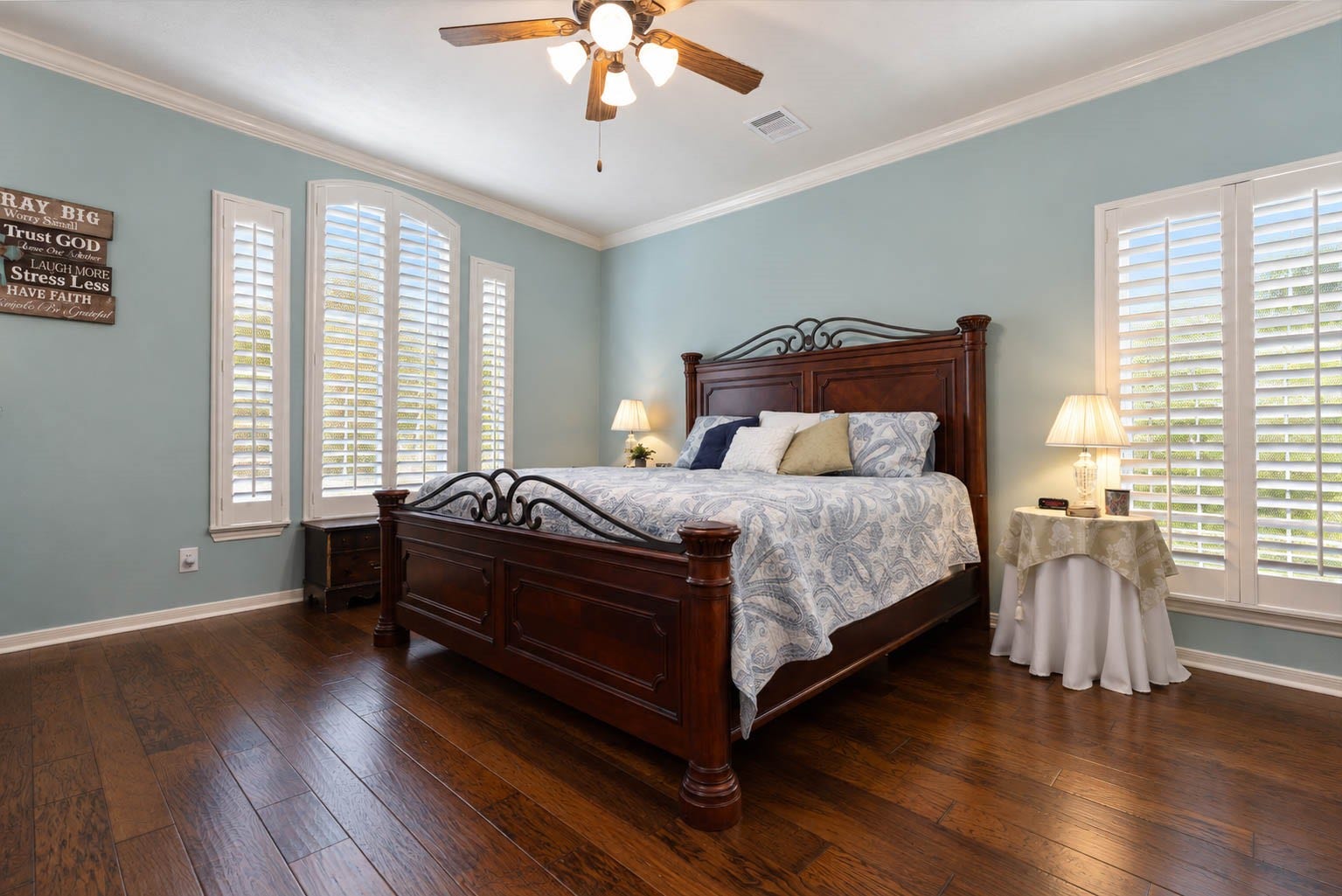 2532 Oak Dale Way, Seabrook, TX 77586 The primary bedroom carries the homes elegance with hardwood floors, graceful crown molding, and an abundance of windows dressed in plantation shutters. Soft painted walls, a ceiling fan, and a charming arched window complete this restful retreat.