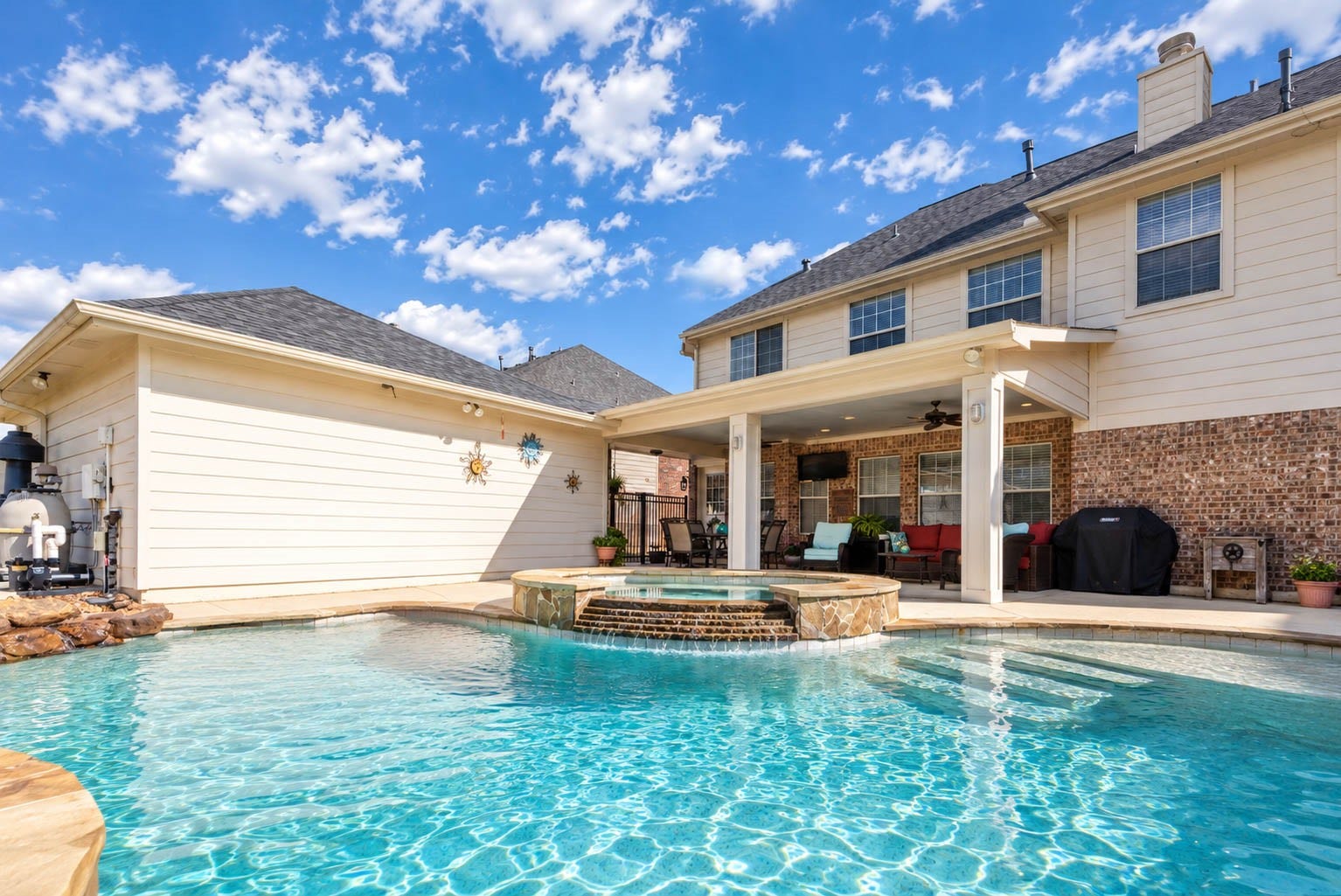 2532 Oak Dale Way, Seabrook, TX 77586 The textured pool deck and a raised spa with stacked stone detail complete the poolside setting.