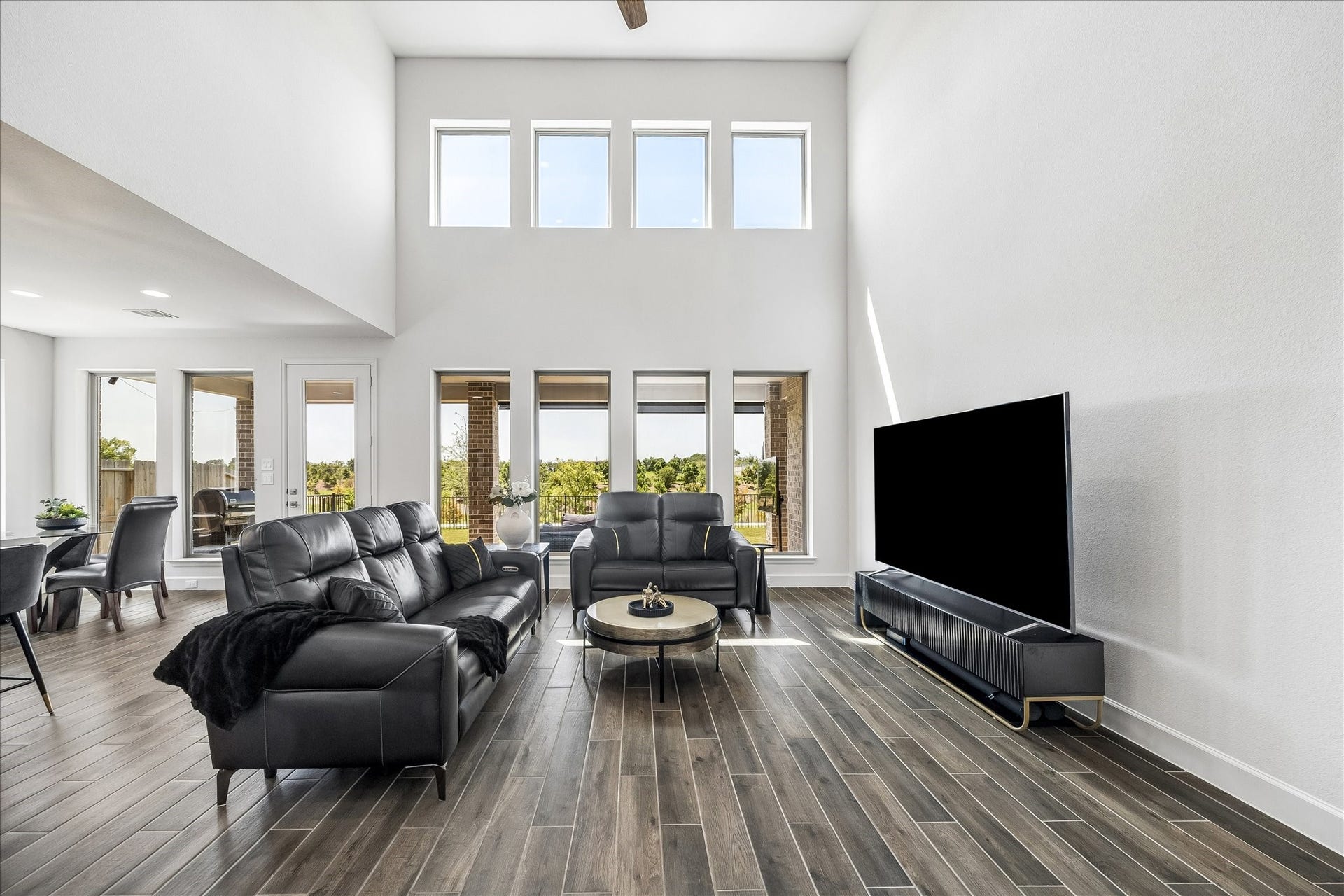 Wall of windows and soaring two-story ceilings fill the family room with abundant natural light