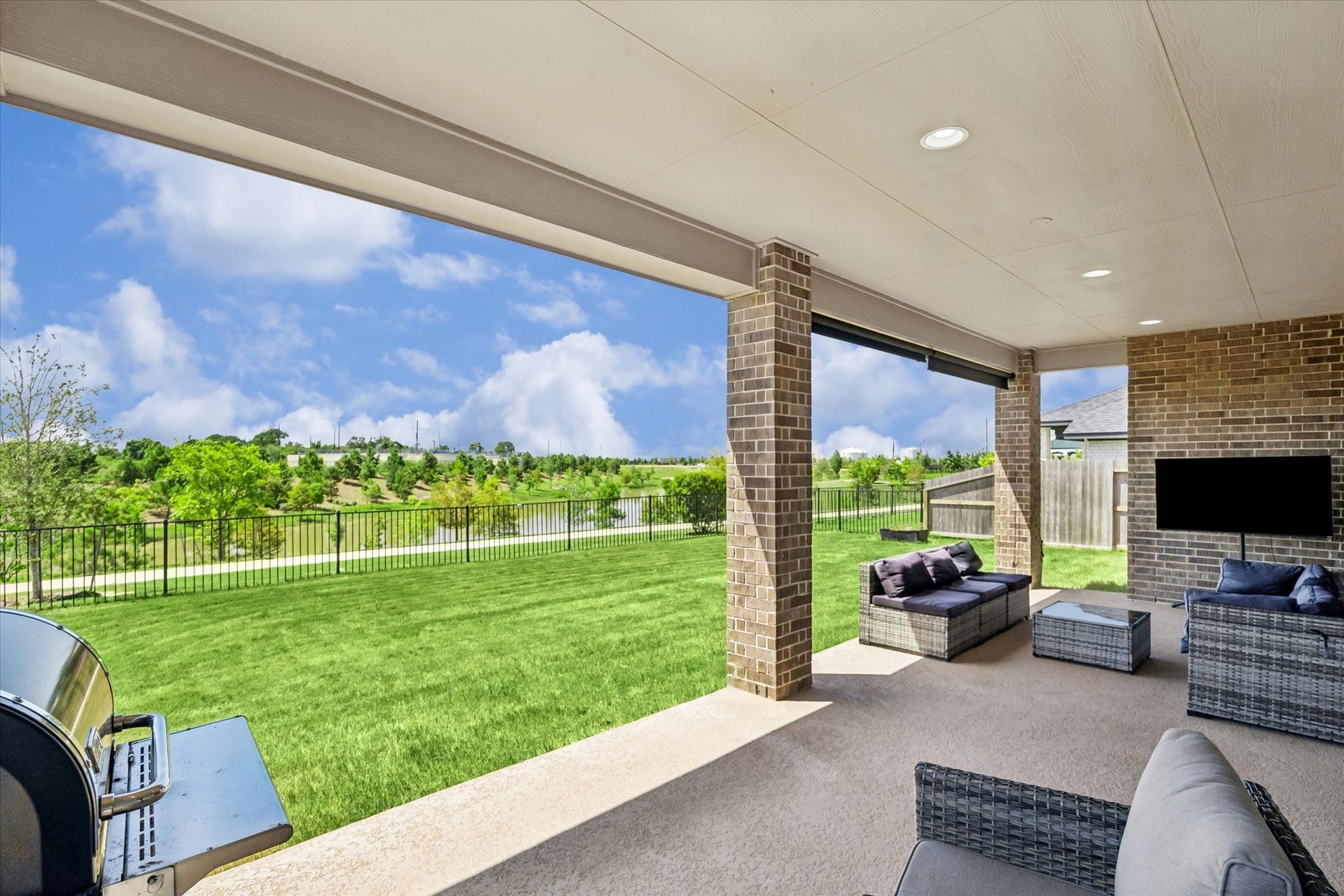 Expansive covered patio overlooking spacious backyard is perfect for year-round outdoor living and entertaining