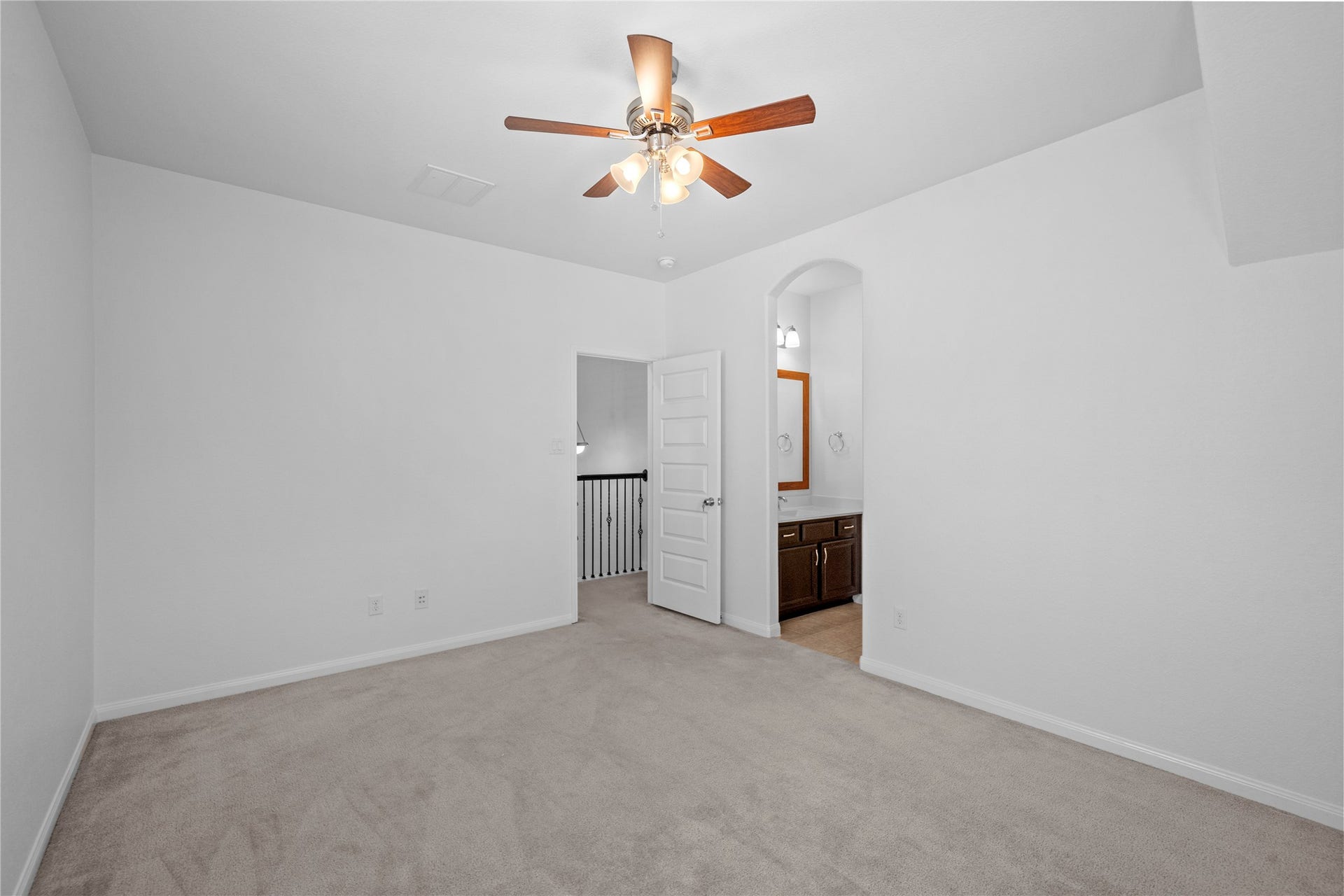 17315 Tomintoul Path, Richmond, TX 77407 Another view of the spacious secondary bedroom, featuring plush carpeting, a ceiling fan, and convenient access to the adjoining bathroom.