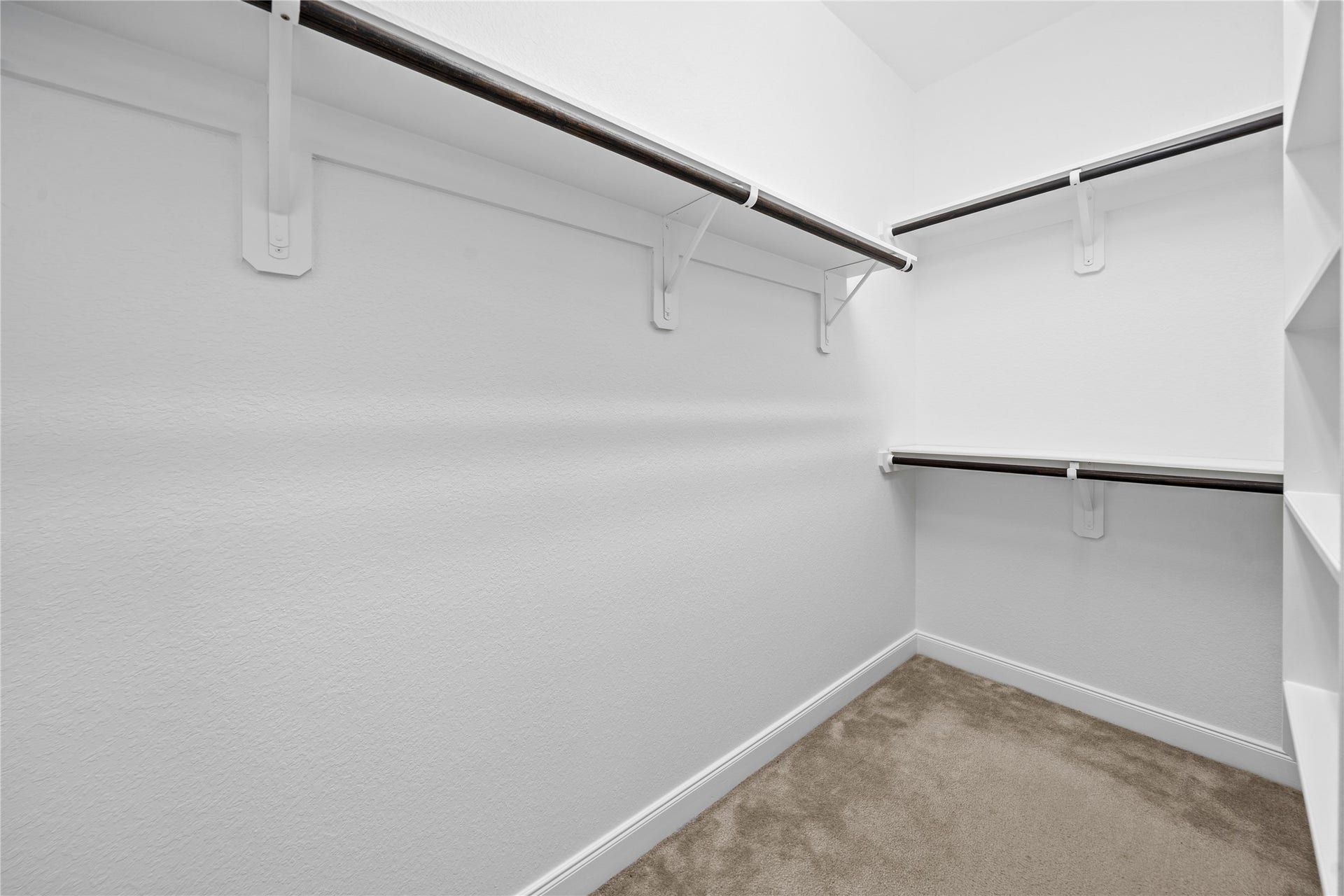 17315 Tomintoul Path, Richmond, TX 77407 A generously sized walk-in closet provides extensive hanging capacity, integrated shelving, and a clean, functional layout designed for effortless organization.