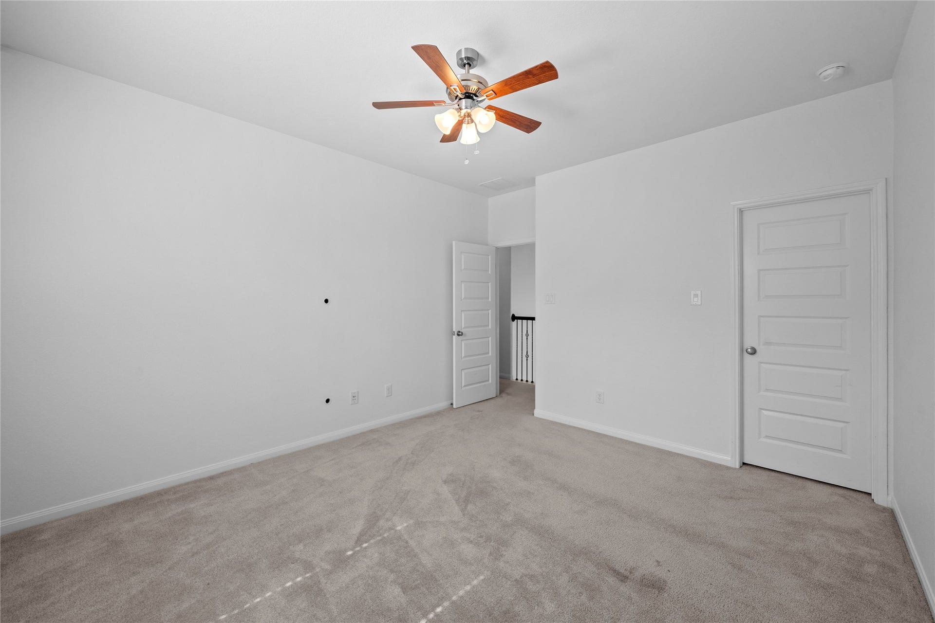17315 Tomintoul Path, Richmond, TX 77407 Alternate view of the bedroom, highlighting the generous floor space, plush carpeting, ceiling fan, and convenient closet access.