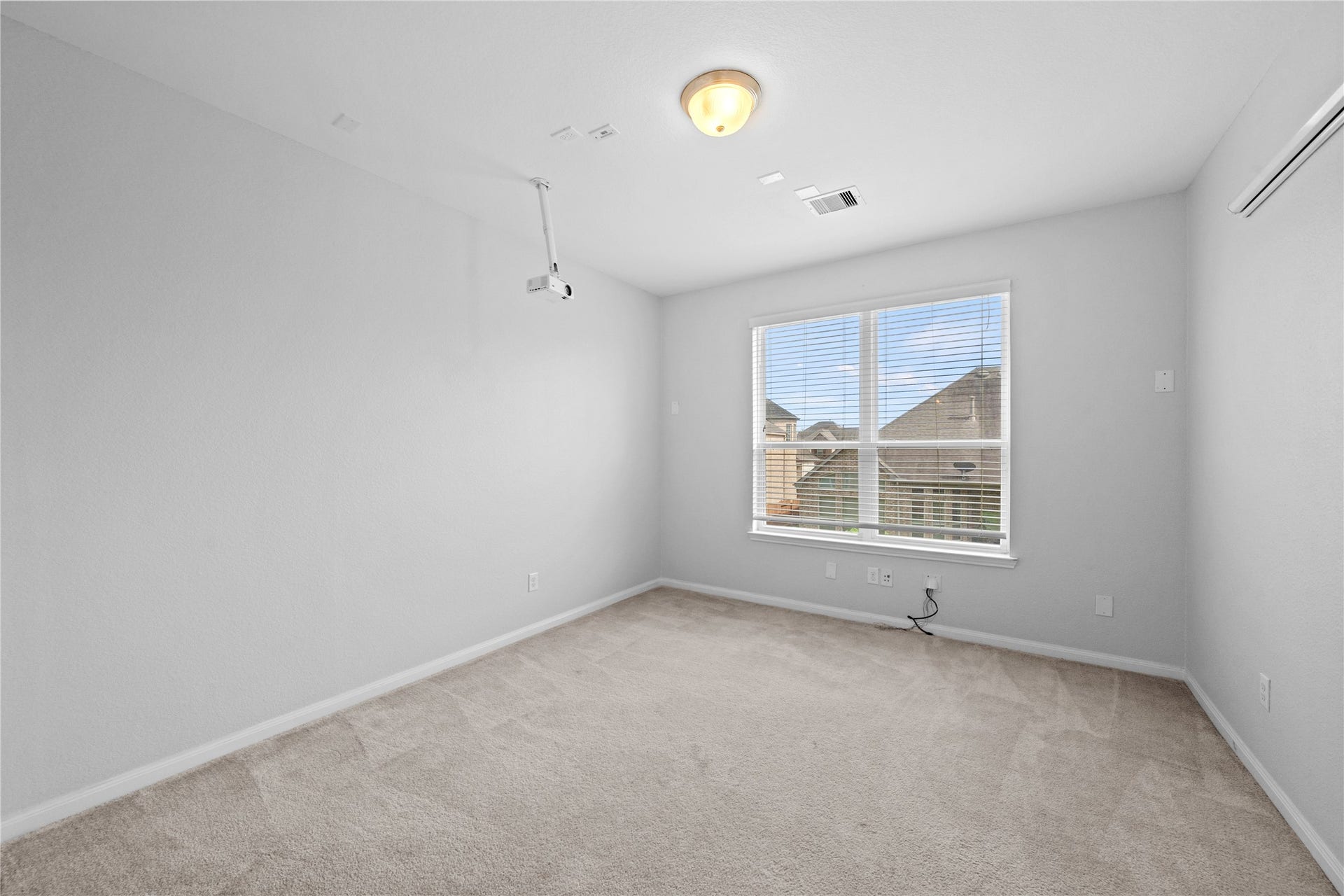 17315 Tomintoul Path, Richmond, TX 77407 Spacious media room featuring a ceiling-mounted projector, large viewing wall, and ample space for comfortable seating and entertainment.