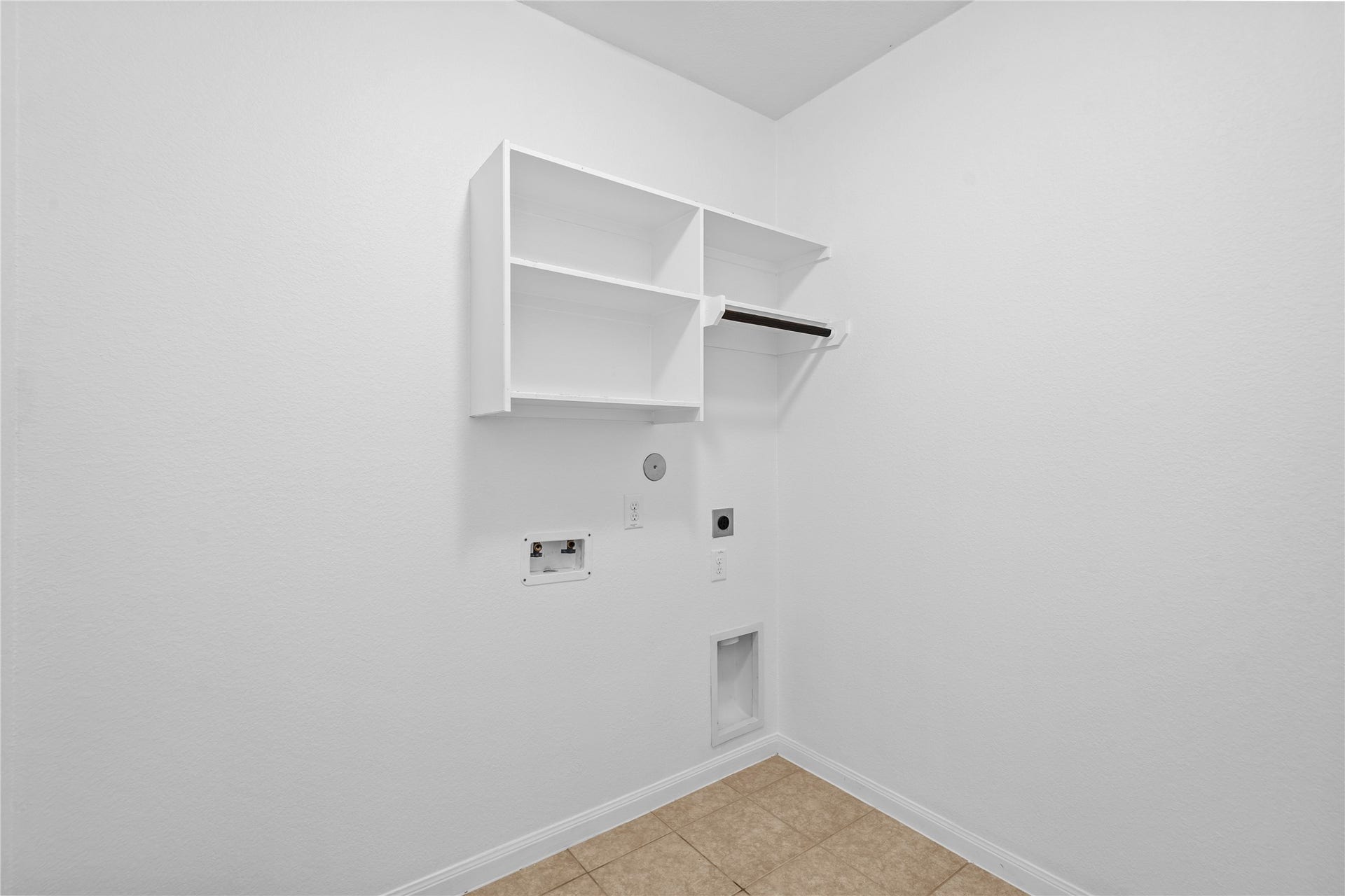 17315 Tomintoul Path, Richmond, TX 77407 A dedicated second-floor laundry room provides washer and dryer connections, overhead shelving, and a streamlined design for convenient household care.