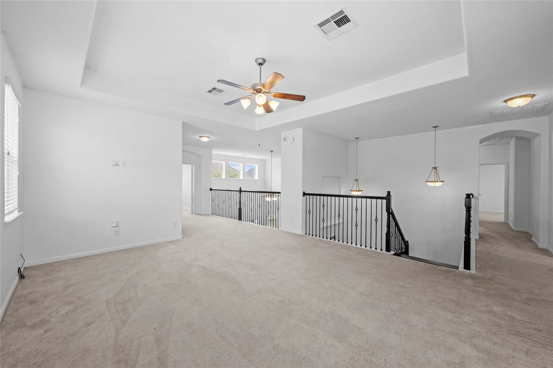 17315 Tomintoul Path, Richmond, TX 77407 The spacious upstairs game room offers flexible space for entertainment, relaxation complete with a tray ceiling and open views to the family area below.